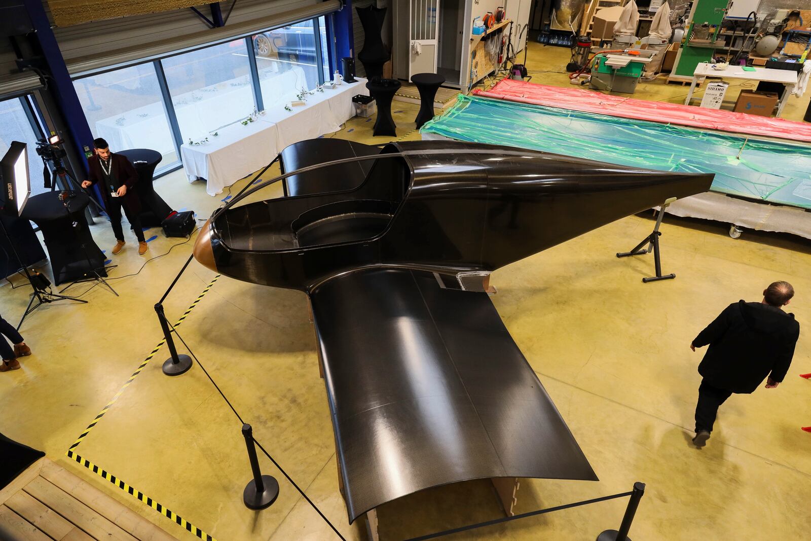 The Climate Impulse, a plane powered by liquid hydrogen, is displayed in a hangar in Les Sables d'Olonne, France on Thursday, Feb. 13, 2025. (AP Photo/Yohan Bonnet)