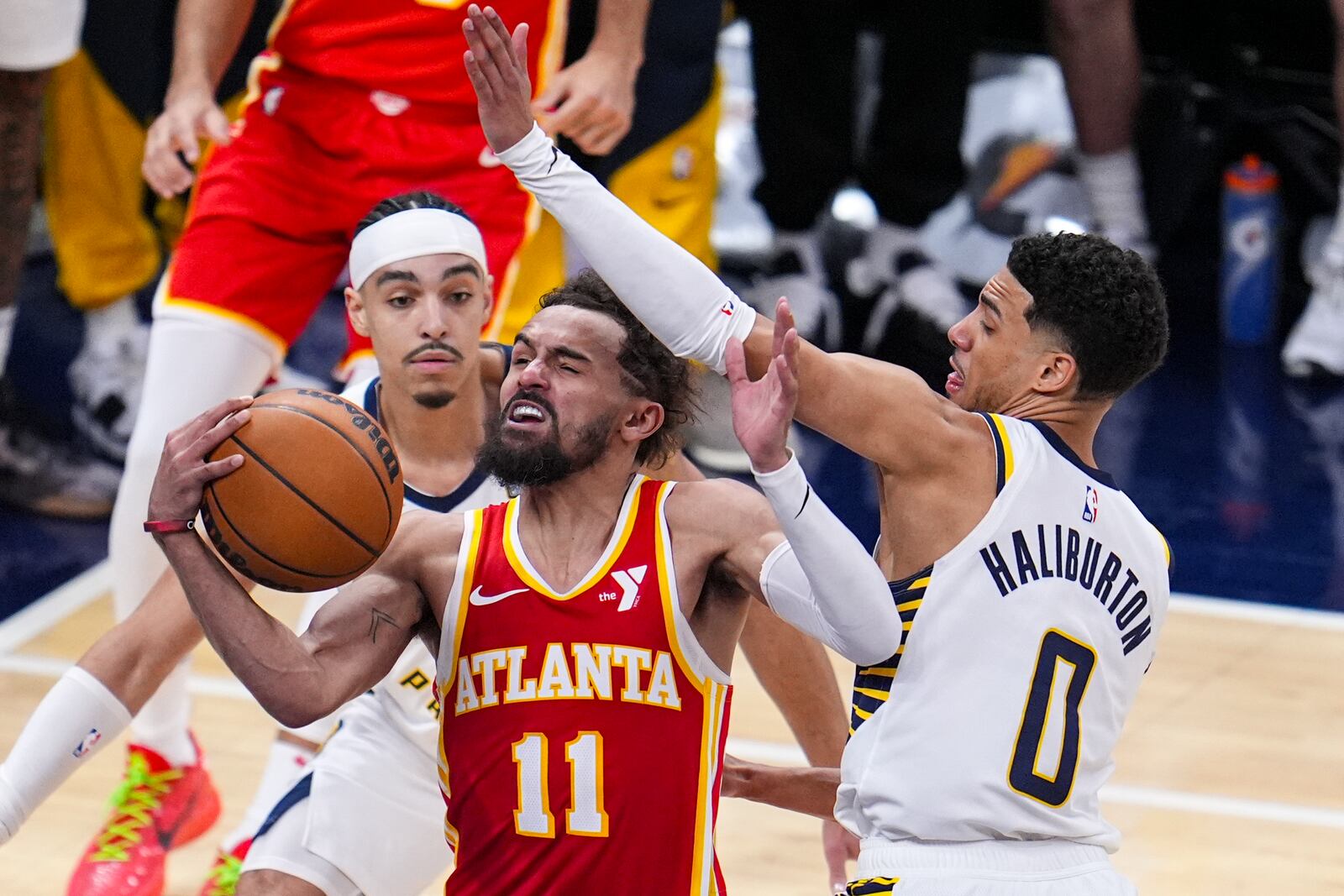 Atlanta Hawks guard Trae Young (11) is fouled by Indiana Pacers guard Tyrese Haliburton (0) as he shoots during the second half of an NBA basketball game in Indianapolis, Saturday, Feb. 1, 2025. (AP Photo/Michael Conroy)