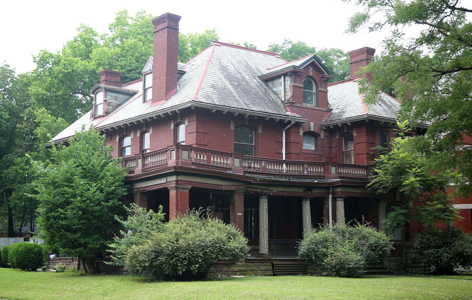 This home was built in 1906 for Thomas E. Tucker, president of the Gem City Boiler Company.
The Tucker house, located in the Dayton View Historic District, features Italian Renaissance style, apparent in the arched windows, pedimented dormer windows and the low-pitched hip roof. 
However, the veranda which conceals much of the façade is built in the Classical Revival style with a dentil entablature and balustrade supported by fluted Doric columns. LISA POWELL / STAFF
