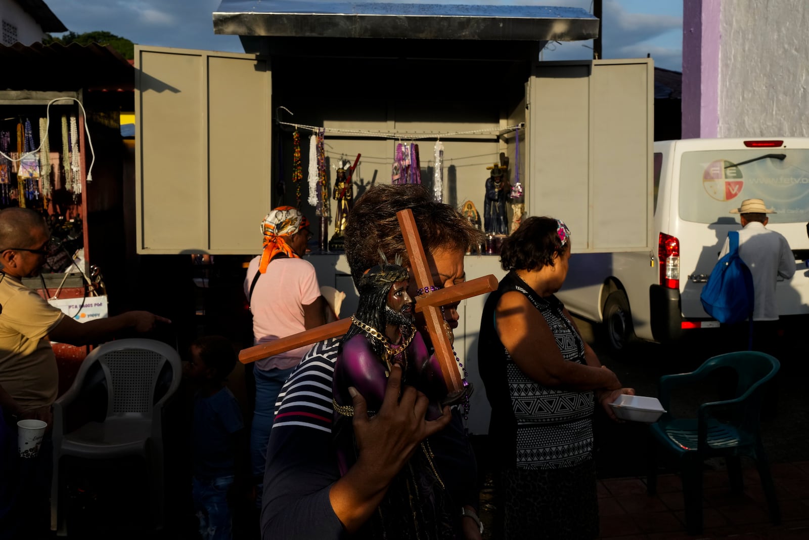 A pilgrim carries a replica of the Black Christ in Portobelo, Panama, early Monday, Oct. 21, 2024, during a festival celebrating the iconic statue that was found on the shore in 1658. (AP Photo/Matias Delacroix)