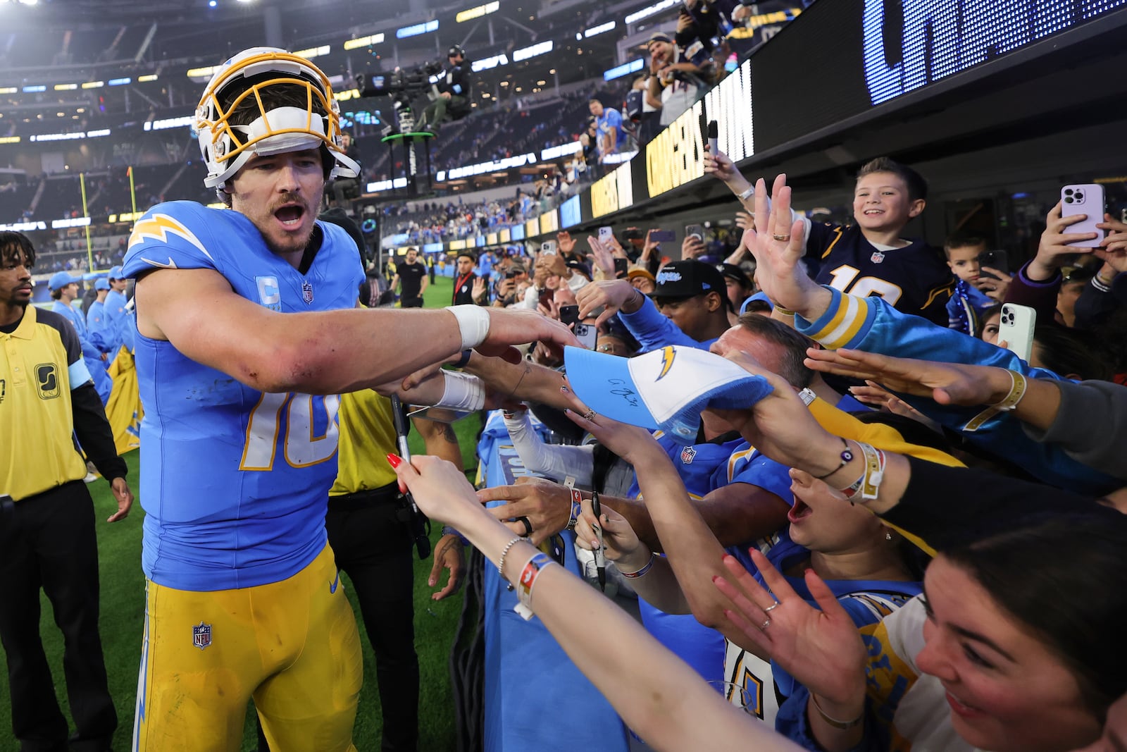 Los Angeles Chargers quarterback Justin Herbert (10) greets fans after a win over the Denver Broncos in an NFL football game Thursday, Dec. 19, 2024, in Inglewood, Calif. (AP Photo/Ryan Sun)