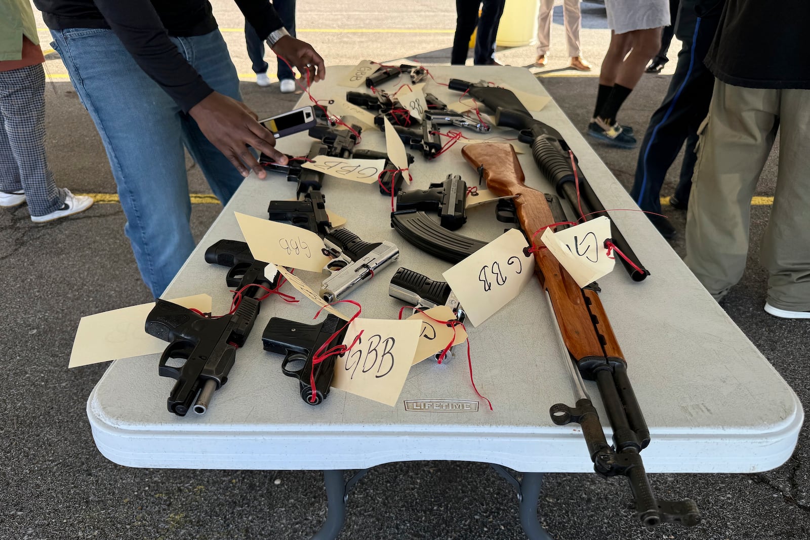 New Orleans police collected more than 30 guns at a gun buyback program exchanging firearms for PlayStations, Tuesday, Dec. 31, 2024, in New Orleans. (AP Photo/Jack Brook)