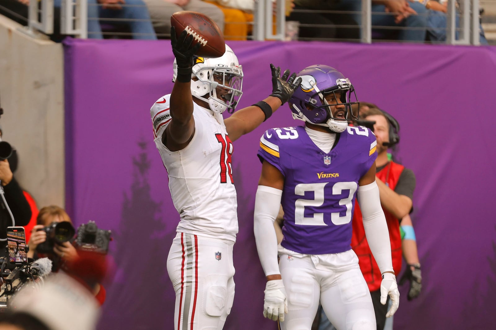 Arizona Cardinals wide receiver Marvin Harrison Jr. (18) celebrates in front of Minnesota Vikings cornerback Fabian Moreau (23) after catching a 15-yard touchdown pass during the second half of an NFL football game Sunday, Dec. 1, 2024, in Minneapolis. (AP Photo/Bruce Kluckhohn)