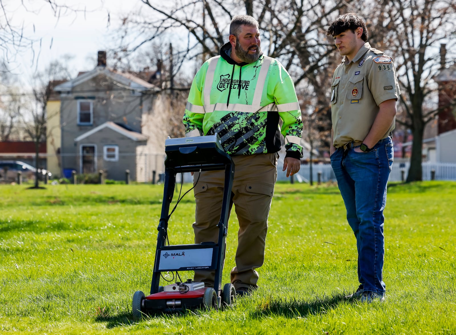 Carl Goyette, left, with The Underground Detective, uses ground penetrating radar at Symmes Park in Hamilton Wednesday, March 20, 2024 in Hamilton. Goyette is helping Eagle Scout candidate Zack Kramer locate the remains of Revolutionary War soldier, Private Paul Bonnel and his wife Mary Bonnel. NICK GRAHAM/STAFF