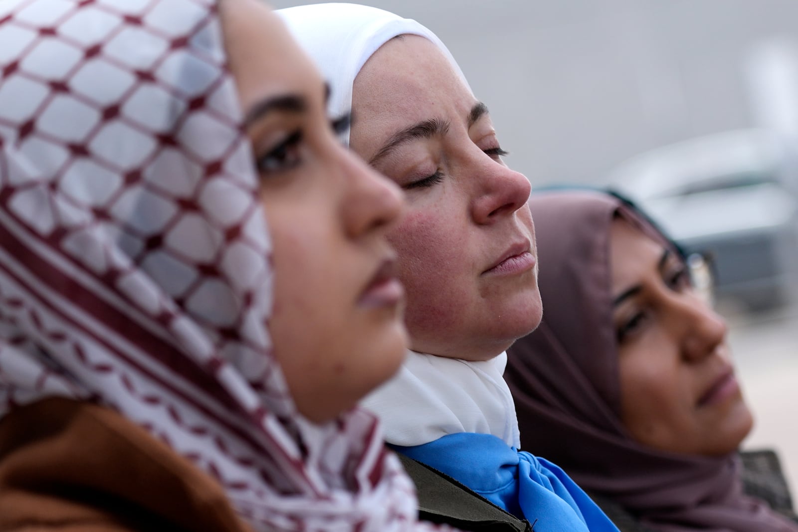 Amina Barhumi, center, Advocacy and Policy lead of Muslim Civic Coalition, prays with Council on American-Islamic Relations members, outside the Will County Courthouse where a jury found defendant Joseph Czuba found guilty of murder and hate crime charges, Friday, Feb. 28, 2025, in Joliet, Ill. (AP Photo/Nam Y. Huh)