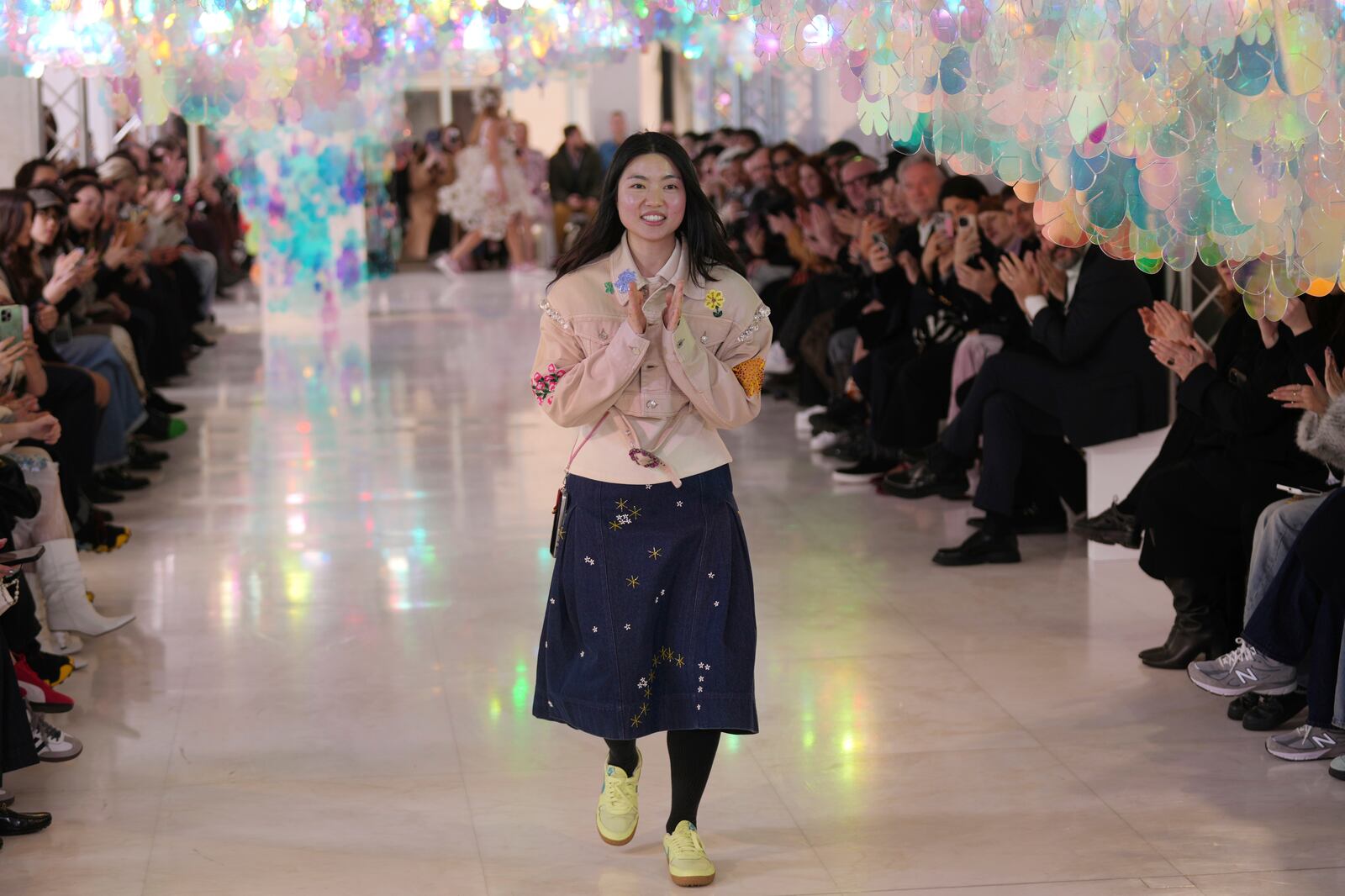 Creative Director Susan Fang acknowledges the applause at the end of her Fall/Winter 2025-2026 Women's collection presented in Milan, Italy, Sunday, March 2, 2025. (AP Photo/Antonio Calanni)