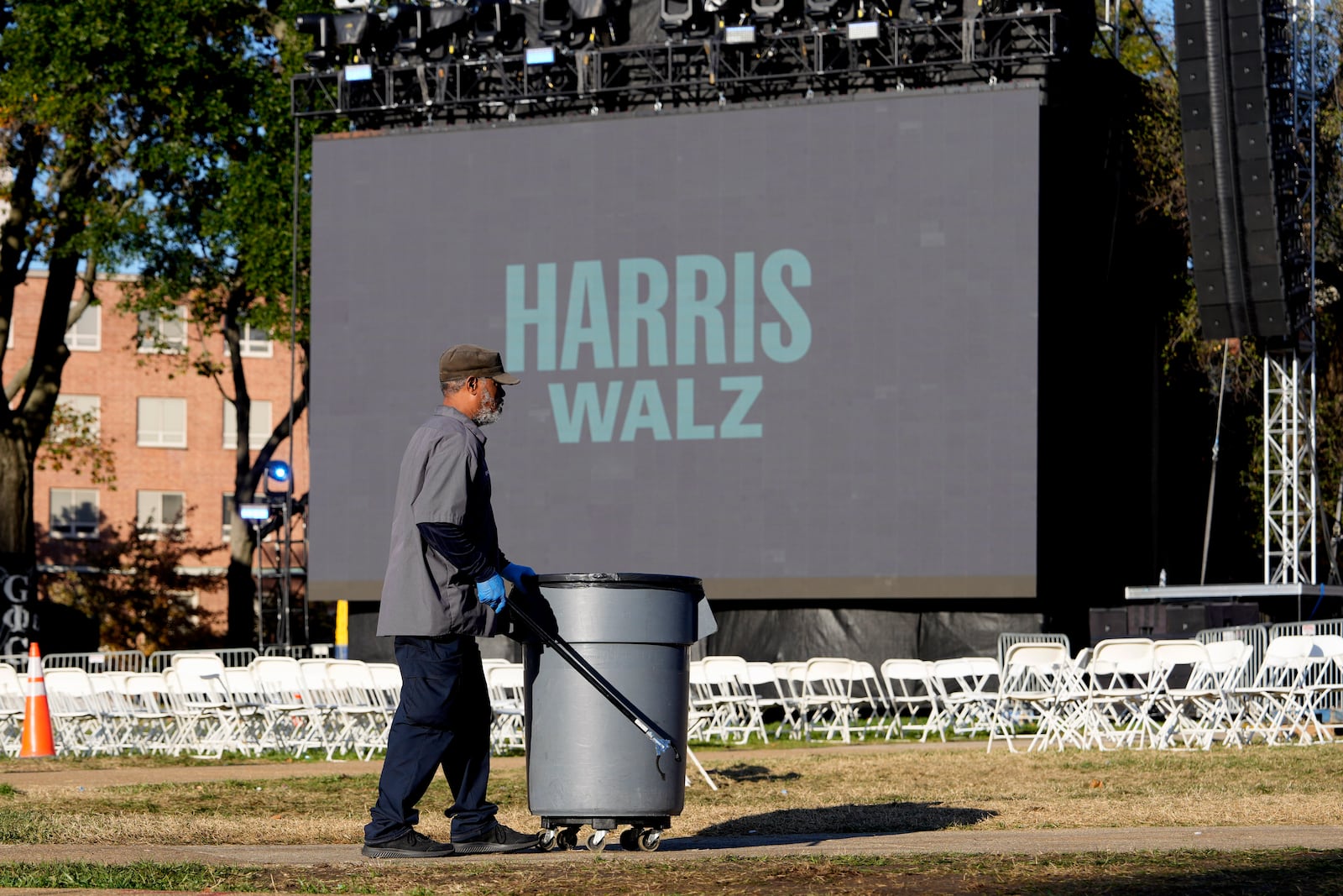 Eric Brown picks up trash left behind from Democratic presidential nominee Vice President Kamala Harris' election night campaign watch party Wednesday, Nov. 6, 2024, on the campus of Howard University in Washington. (AP Photo/David J. Phillip)