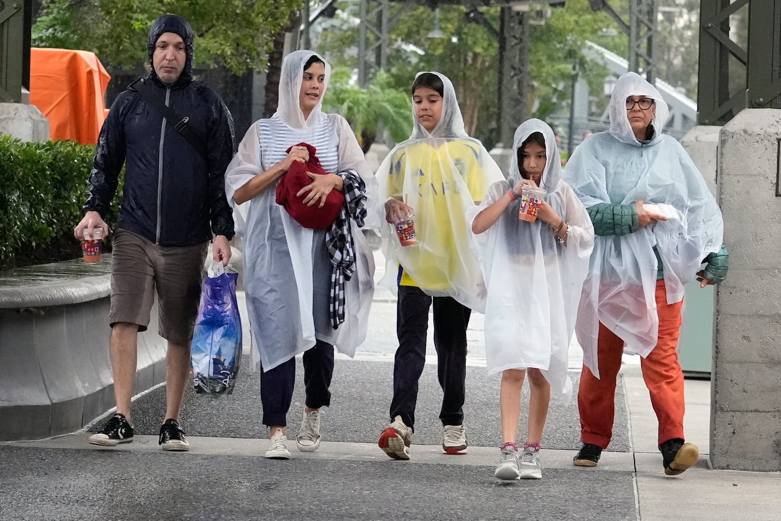 Tourists exit the Disney Springs entertainment complex before the arrival of Hurricane Milton, Wednesday, Oct. 9, 2024, in Lake Buena Vista, Fla. (AP Photo/John Raoux)