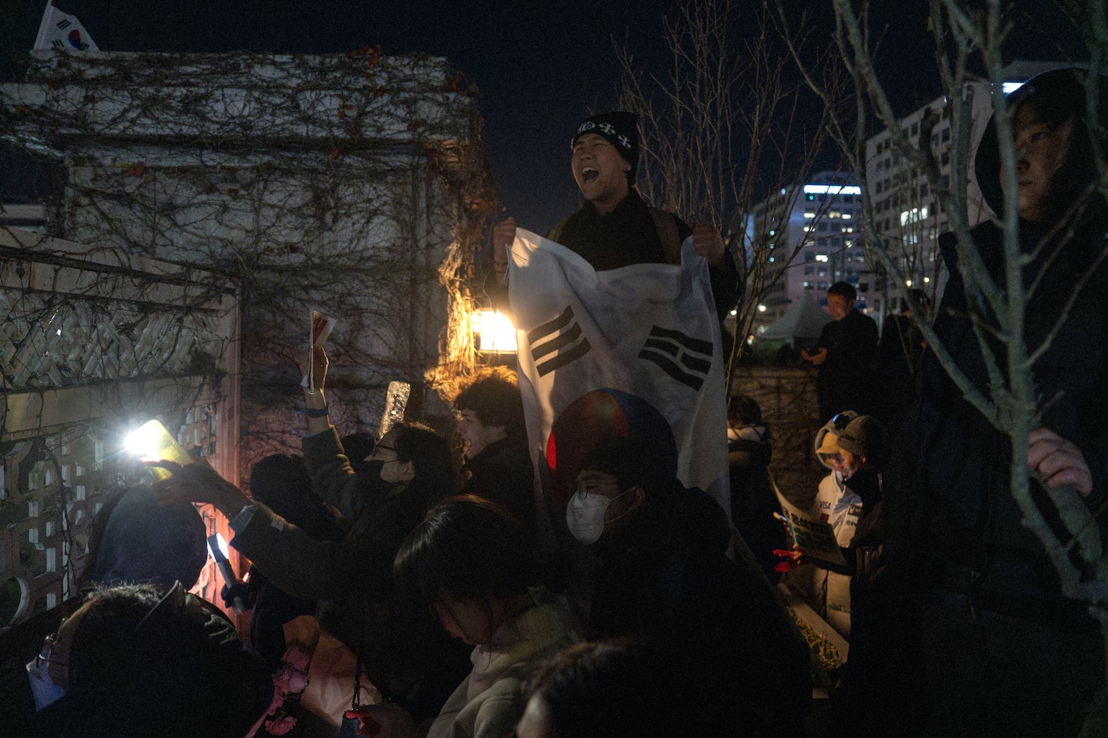 Protesters react outside the National Assembly after a failed impeachment of South Korean President Yoon Suk Yeol, following the President's short-lived martial law declaration in Seoul, South Korea, Saturday, Dec. 7, 2024. (AP Photo/Ng Han Guan)