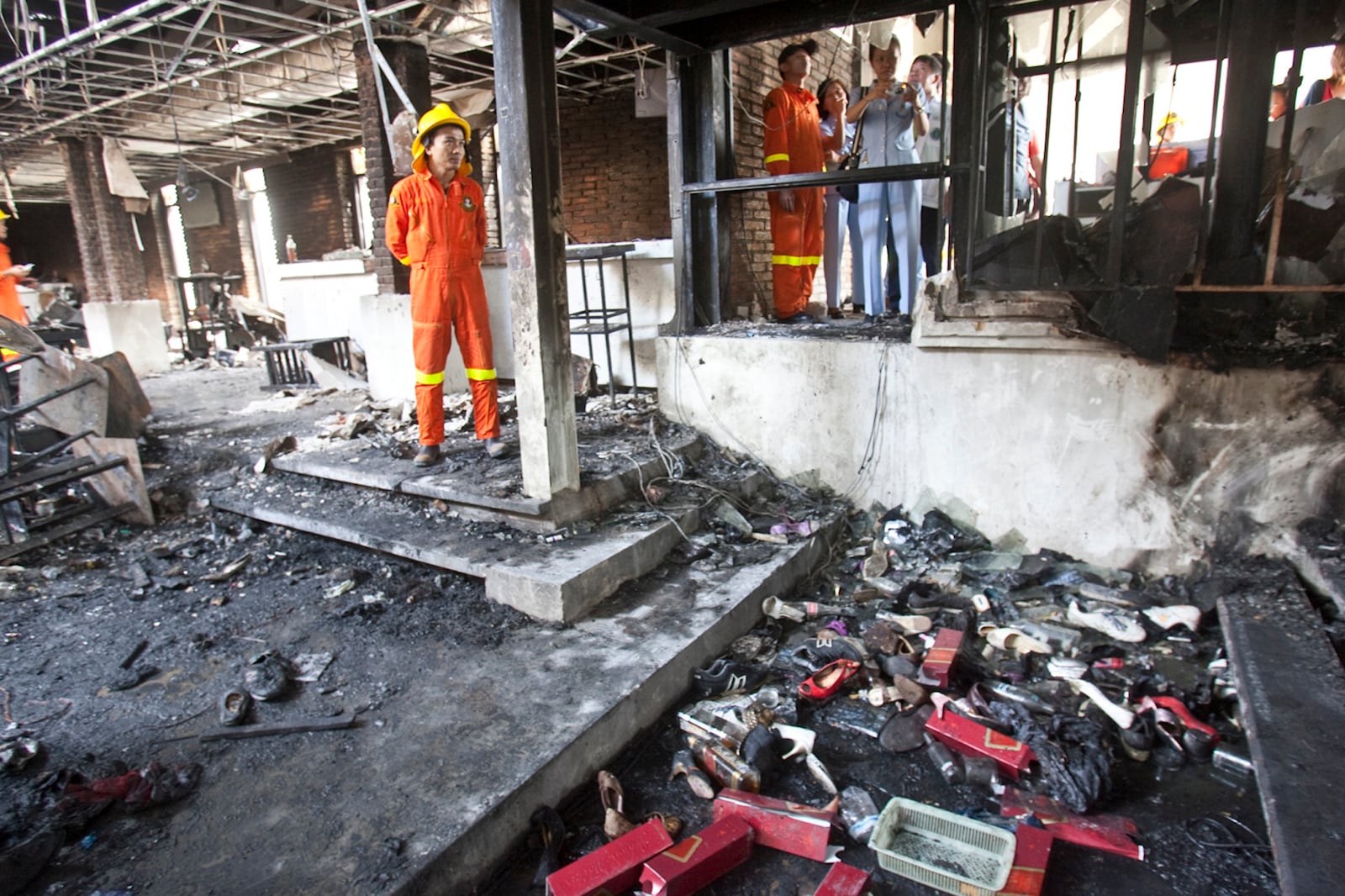 FILE - Fire and Rescue officials along with others inspect the Santika nightclub Thursday, Jan. 1, 2009, in Bangkok, Thailand. (AP Photo/David Longstreath, File)