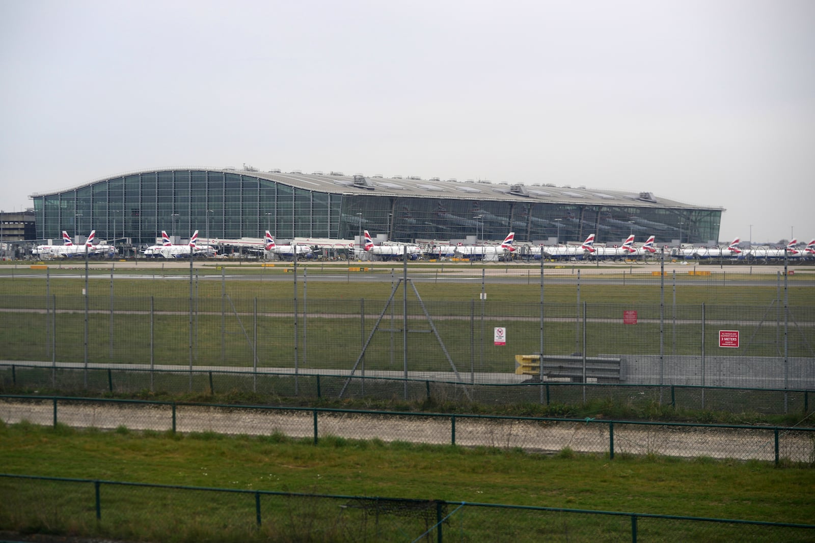 British Airways planes are parked at Terminal 5 as Britain's Heathrow Airport has closed for the full day Friday after an electrical substation fire knocked out its power, disrupting flights for hundreds of thousands of passengers at one of Europe's biggest travel hubs in London, Friday, March 21, 2025.(AP Photo/Kin Cheung)