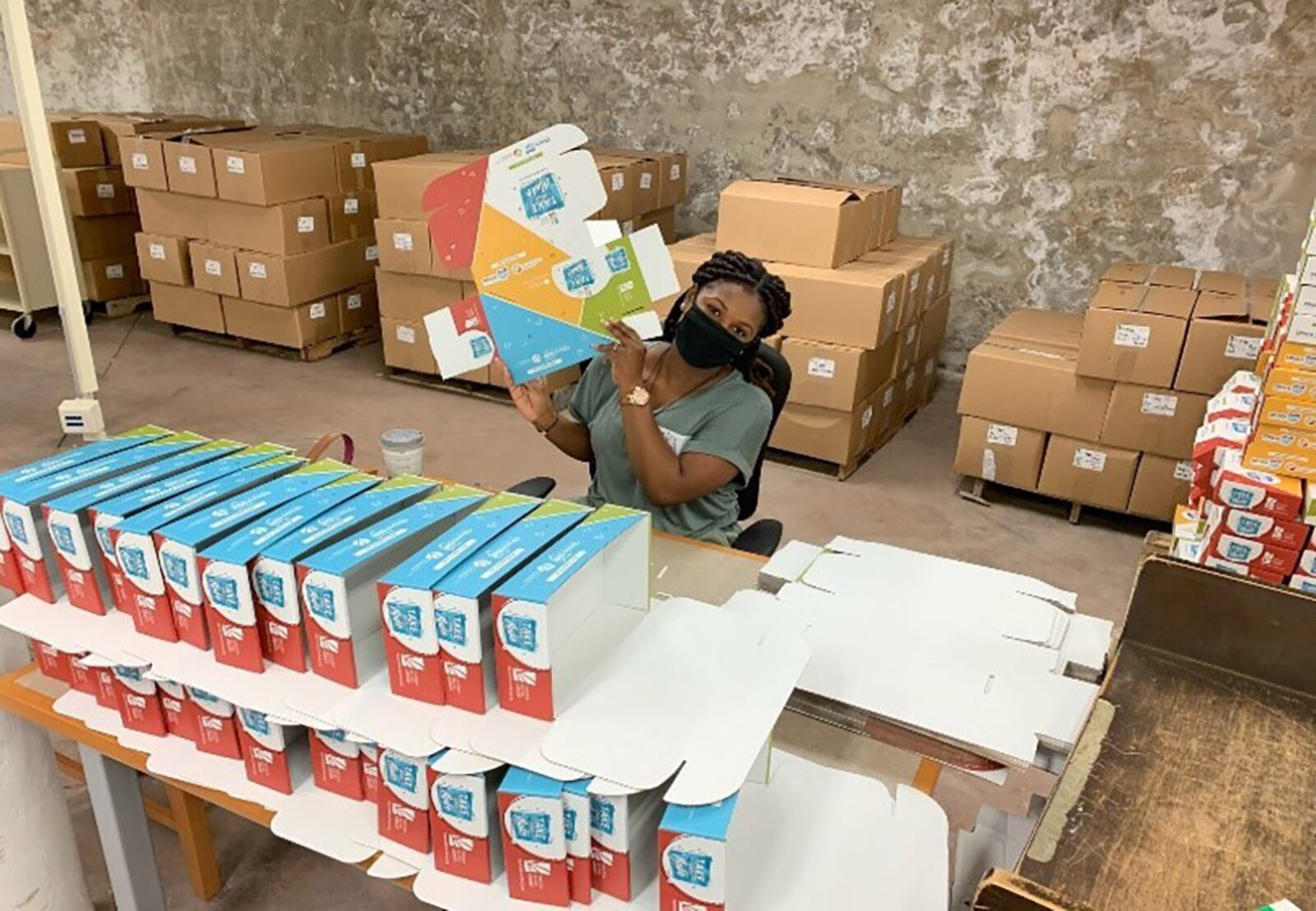 Airman 1st Class Katchee Vedrine puts together a box for the “Take and Make” kits. The volunteer team dedicated 156 total hours to the two-day project at Dayton Metro Library. CONTRIBUTED PHOTO