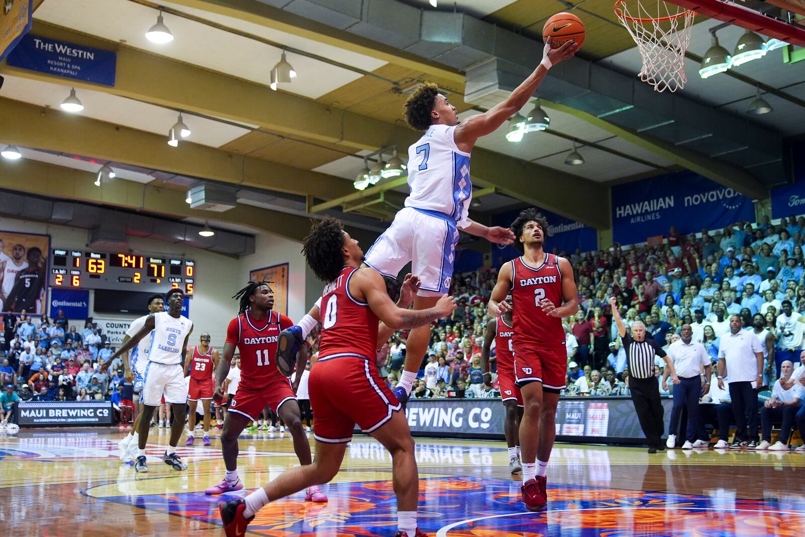 North Carolina guard Seth Trimble (7) goes up for a basket against Dayton guard Javon Bennett (0) and forward Nate Santos (2) during the second half of an NCAA college basketball game at the Maui Invitational Monday, Nov. 25, 2024, in Lahaina, Hawaii. (AP Photo/Lindsey Wasson)