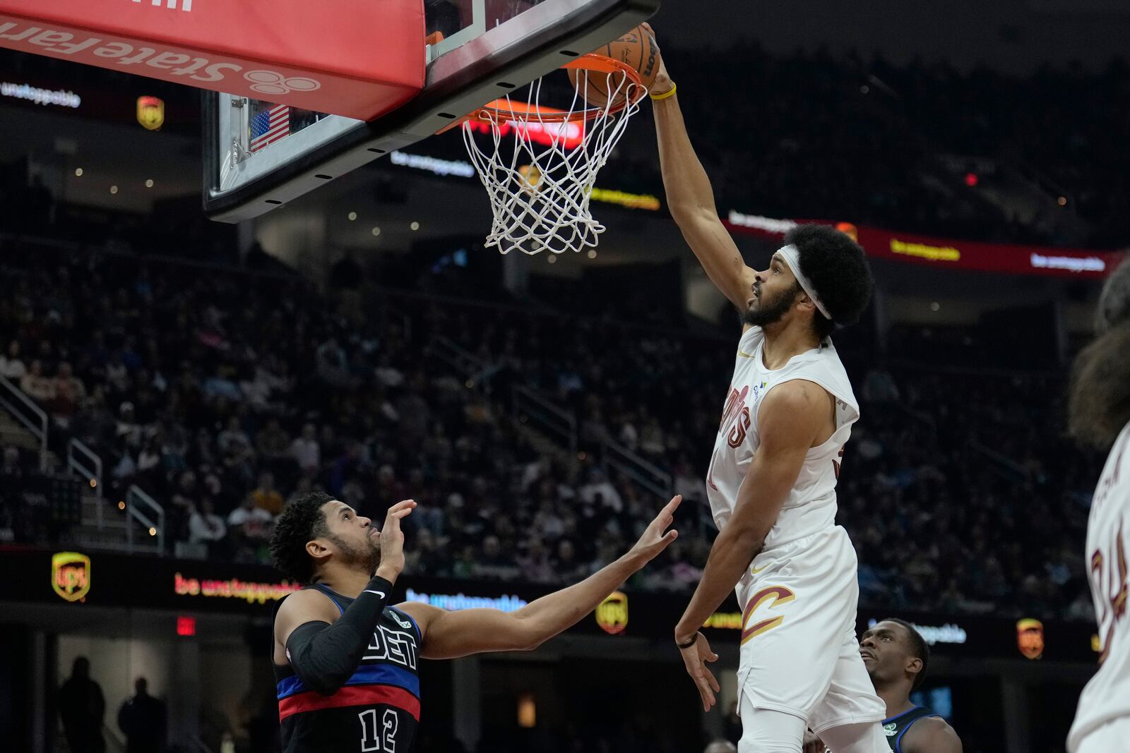 Cleveland Cavaliers center Jarrett Allen, right, dunks in front of Detroit Pistons forward Tobias Harris (12) in the first half of an NBA basketball game, Monday, Jan. 27, 2025, in Cleveland. (AP Photo/Sue Ogrocki)