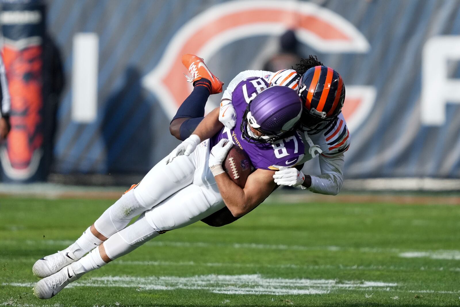 Minnesota Vikings tight end T.J. Hockenson (87) is tackled by Chicago Bears cornerback Terell Smith after a catch during the first half of an NFL football game Sunday, Nov. 24, 2024, in Chicago. (AP Photo/Charles Rex Arbogast)