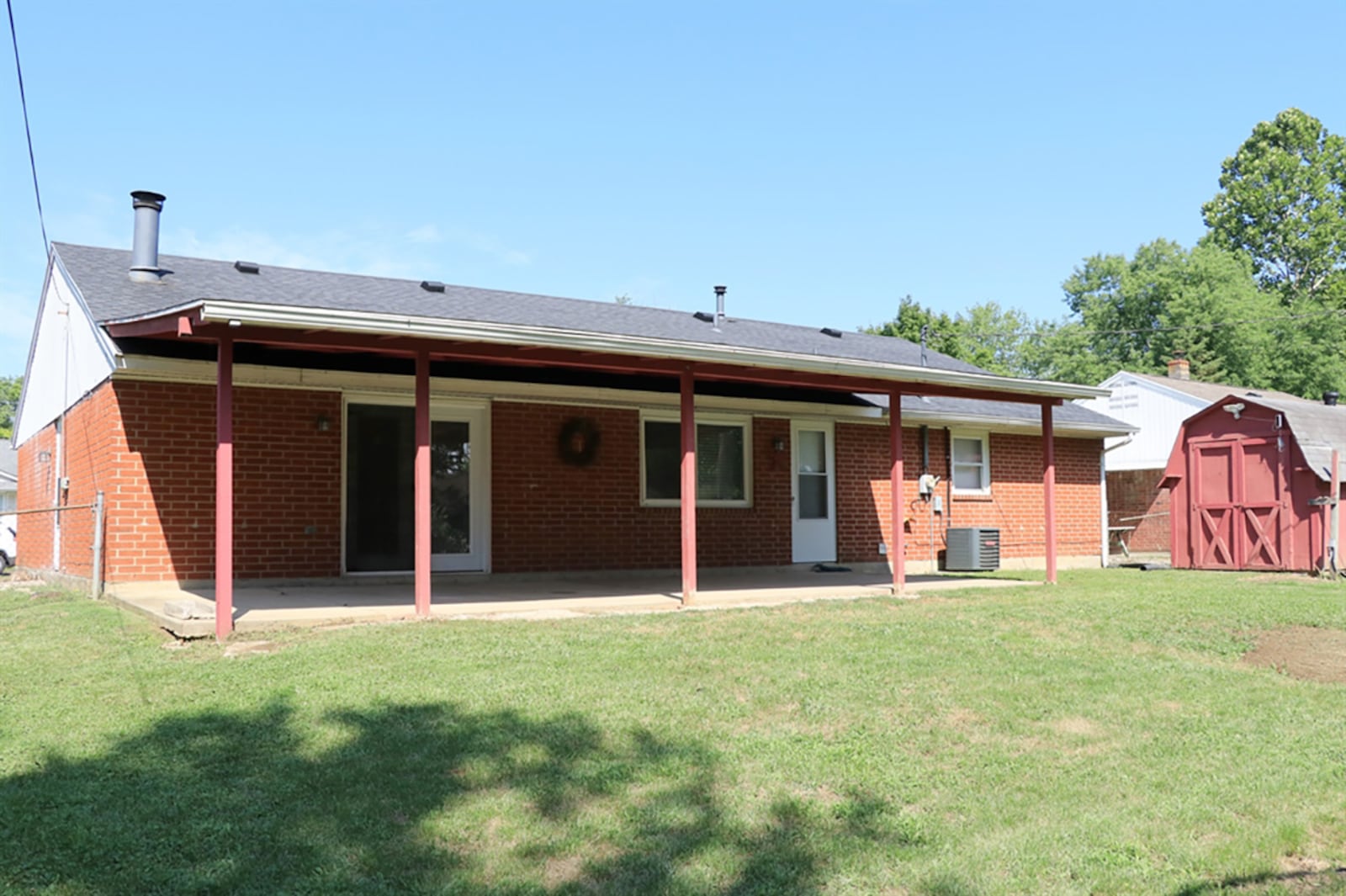 Updated patio doors open from the family room out to a covered concrete patio and fenced back yard. The brick ranch has had several updates, including the gas forced-air furnace, central air conditioning, roof, window and kitchen. CONTRIBUTED PHOTO BY KATHY TYLER