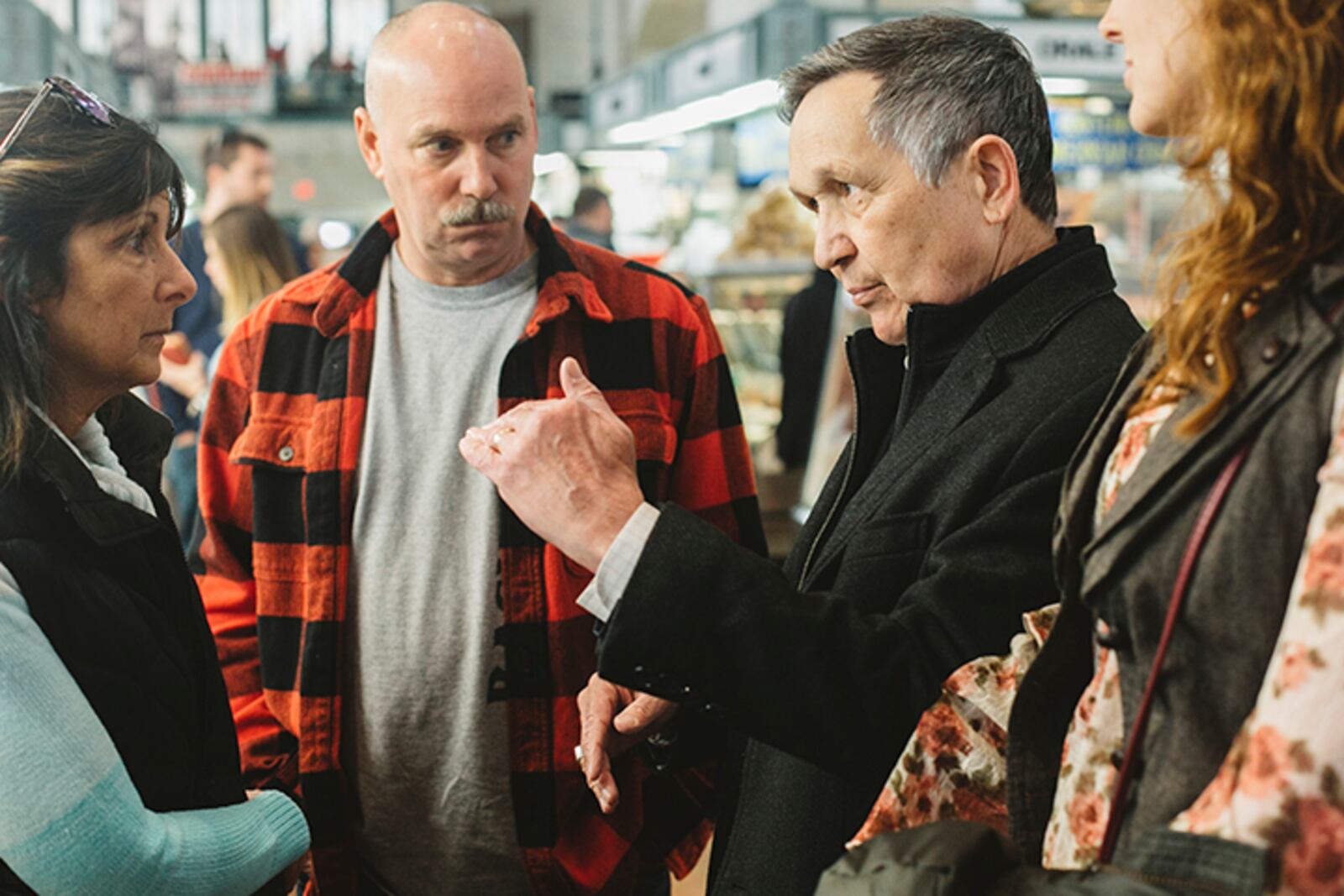 Dennis Kucinich speaks with other shoppers while campaigning and shopping at the West Side Market in Cleveland, Ohio, April 21, 2018. In the May 8 Democratic primary for governor of Ohio, two well-known progressives, Richard Cordray and Dennis Kucinich, are running on differing brands of liberalism that reflect divergences on the left.