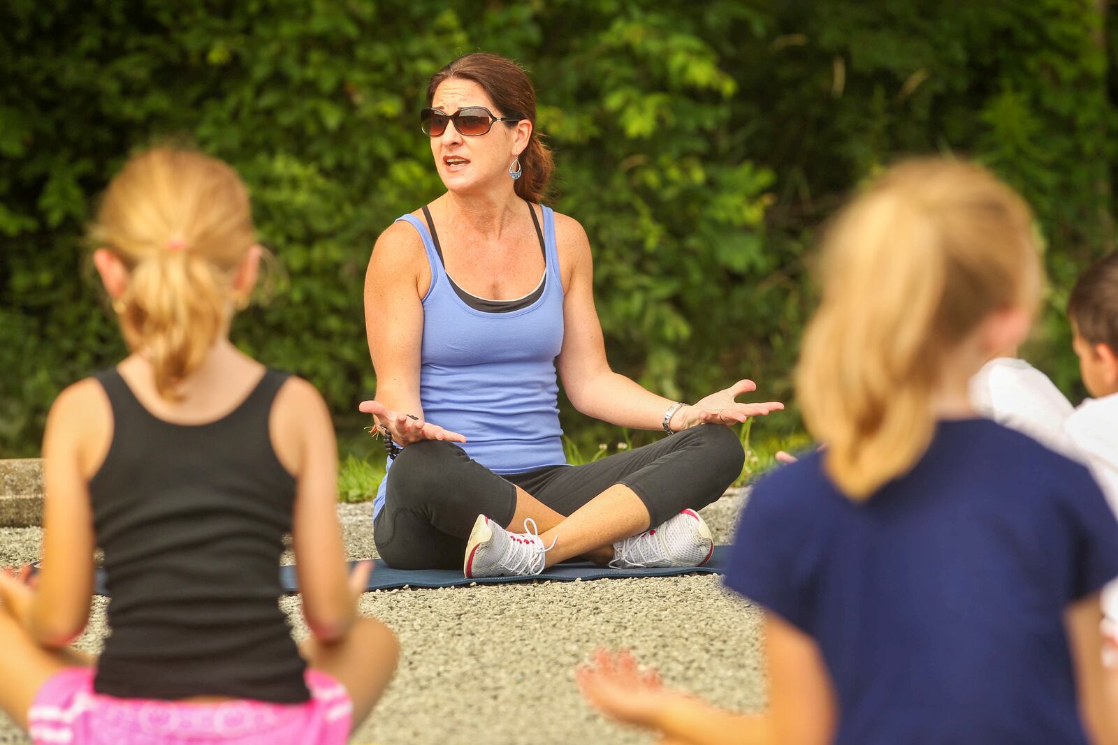 Amanda Brown, a yoga instructor and owner of new Piqua business balanceYoga, leads a class of kids during a Yoga in Nature program at Garbry Big Woods Reserve. Brown started her new yoga business after a number of years in the communications role at a local mental health agency.JIM WITMER / STAFF