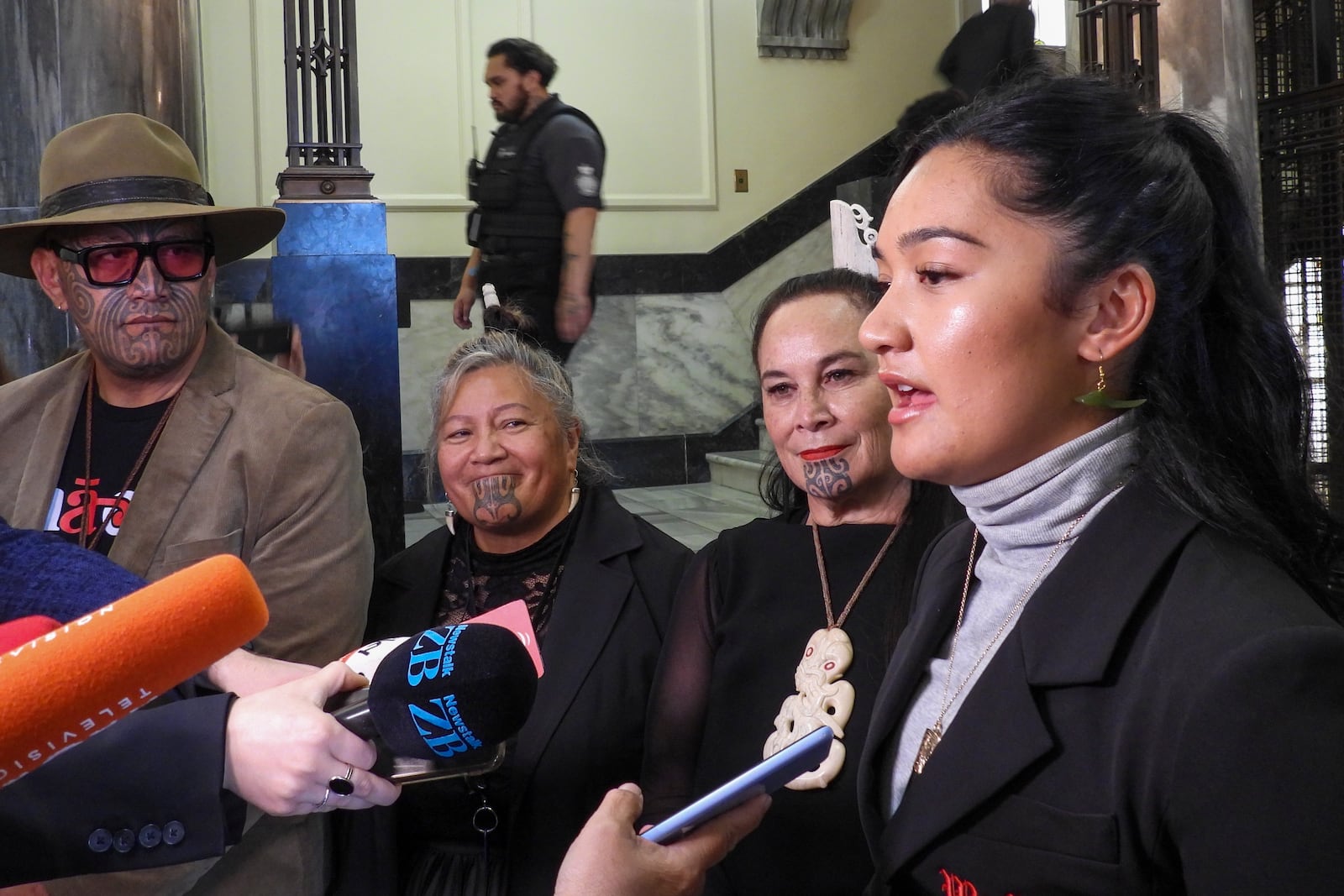 Hana-Rawhiti Maipi-Clarke, right, and her colleagues from Te Haiti Māori, talk to reporters following a protest inside Parliament in Wellington, New Zealand, Thursday, Nov. 14, 2024. (AP Photo/Charlotte McLay-Graham)