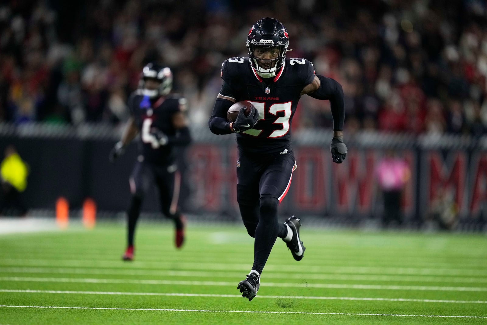 Houston Texans safety Eric Murray (23) returns an interception for a touchdown against the Los Angeles Chargers during the second half of an NFL wild-card playoff football game Saturday, Jan. 11, 2025, in Houston. (AP Photo/Eric Christian Smith)