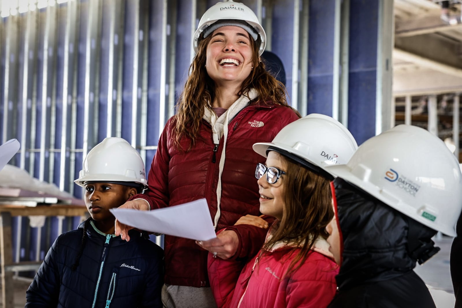 Kendra Stich along with her children, from left, Spring, Olivia and Teddy tour the Greater Dayton School Tuesday February 21, 2023. The school is under construction and is located near Deeds Point MetroPark and should open in the fall. JIM NOELKER/STAFF