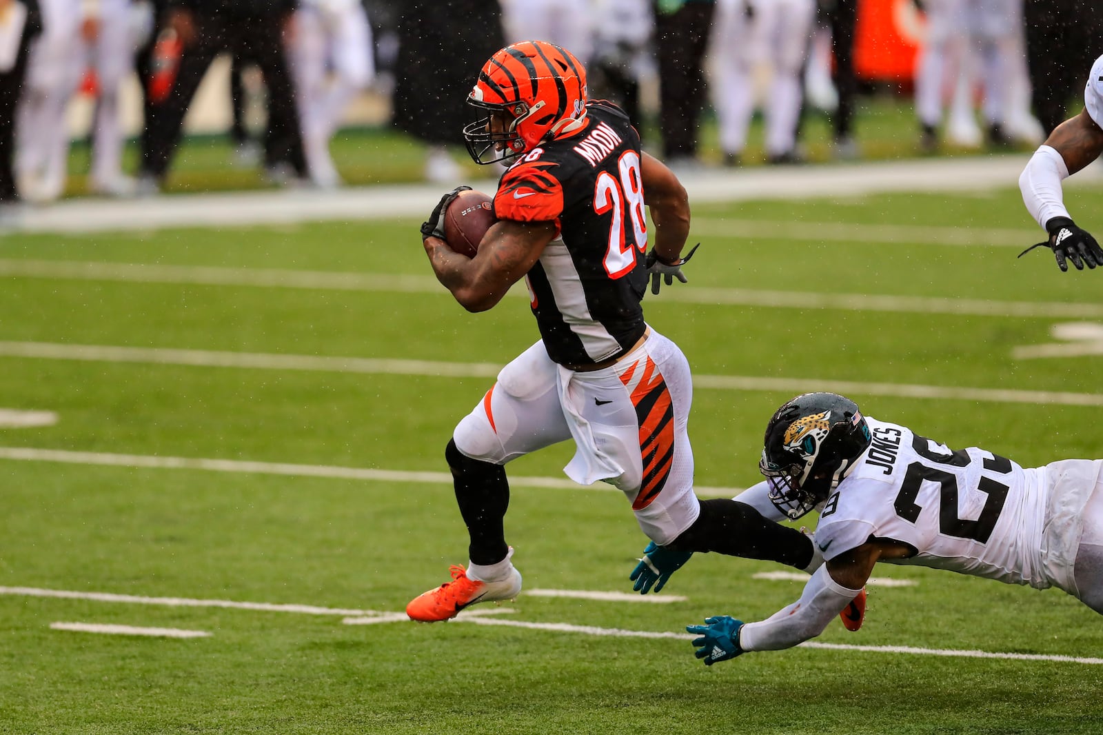 Cincinnati Bengals running back Joe Mixon (28) runs for a touchdown in front of Jacksonville Jaguars strong safety Josh Jones (29) in the second half of an NFL football game in Cincinnati, Sunday, Oct. 4, 2020. (AP Photo/Aaron Doster)