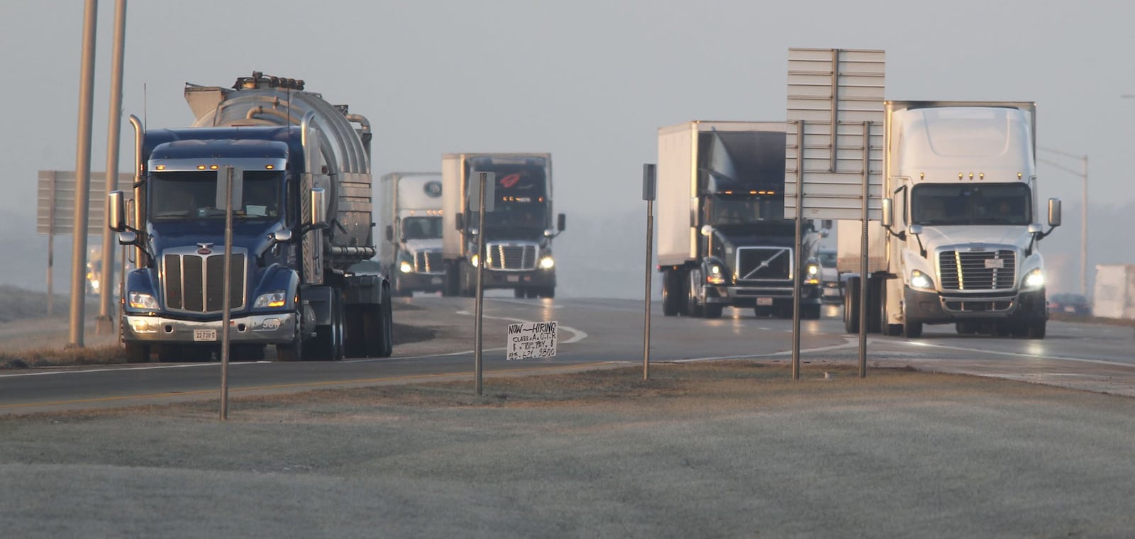 A truck remains parked on the ramp from I-75 northbound to the Rest Area in Fayette County at 7:30 a.m. The increase in truck traffic, mandatory rest periods for drivers and the lack of adequate space for truck parking has left many drivers no alternative other than the side of the ramps for rest breaks. TY GREENLEES / STAFF