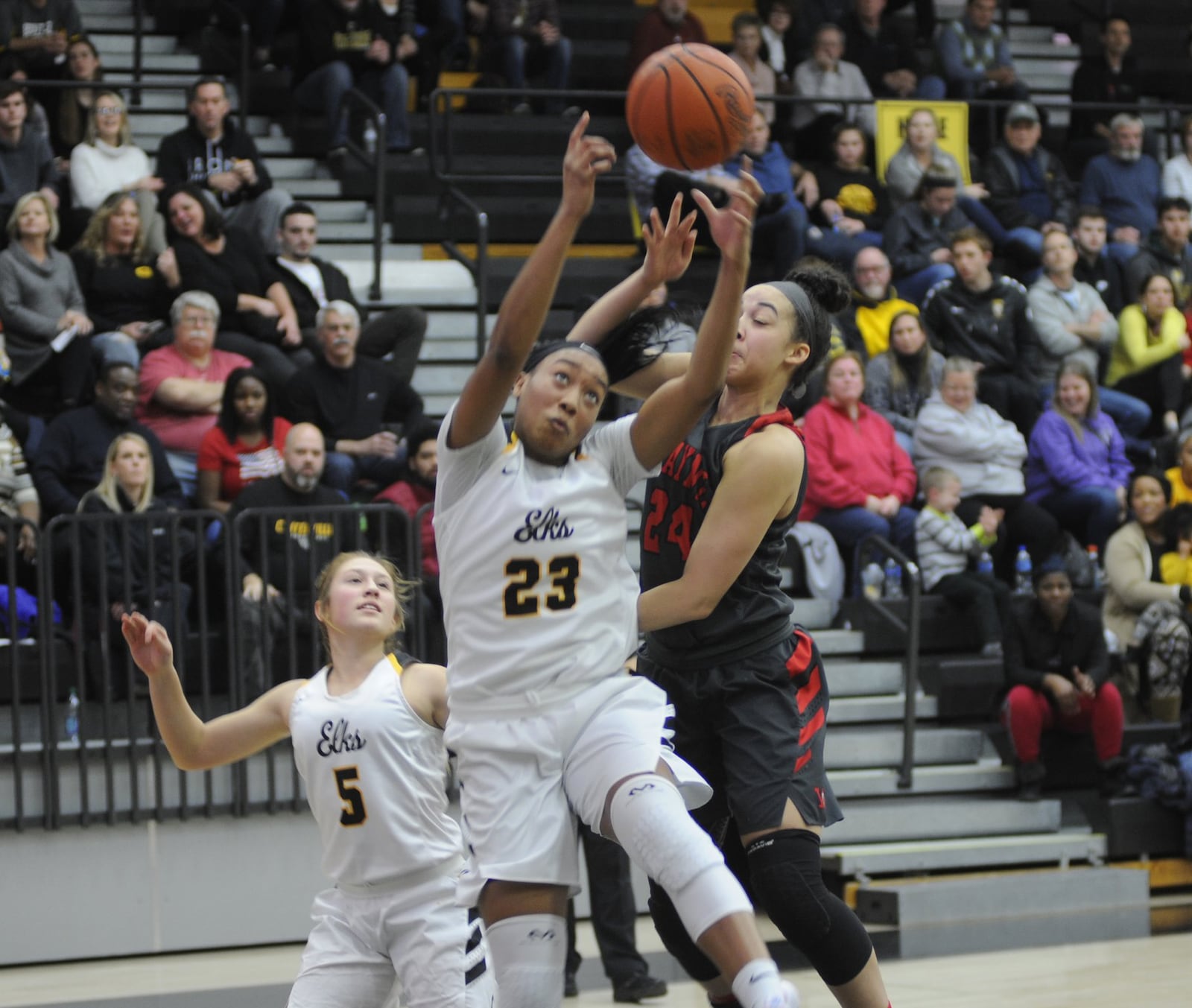 Cotie McMahon (23) and teammate Kenzie Smith (5) contend for a rebound with Wayne’s Jaida Wolfork. Centerville defeated visiting Wayne 66-60 in a girls high school basketball game on Monday, Dec. 17, 2018. MARC PENDLETON / STAFF