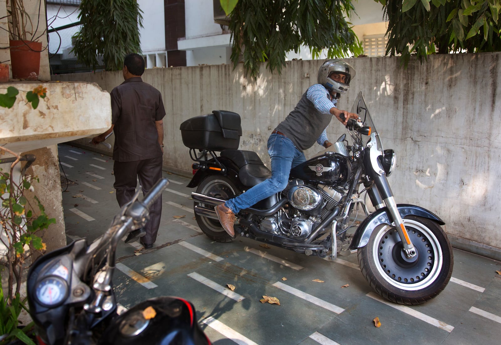 An Indian man parks his Harley Davidson Fat Boy motorcycle in New Delhi, India, March 1, 2017. (AP Photo/Manish Swarup, File)