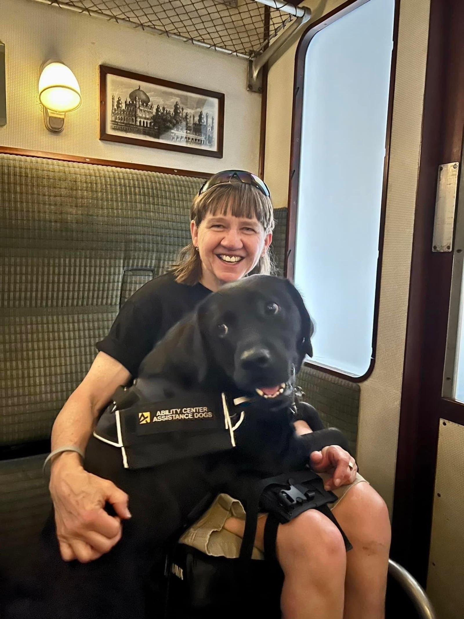 Holly Koester and her service dog Flare on a train ride in Florida. CONTRIBUTED