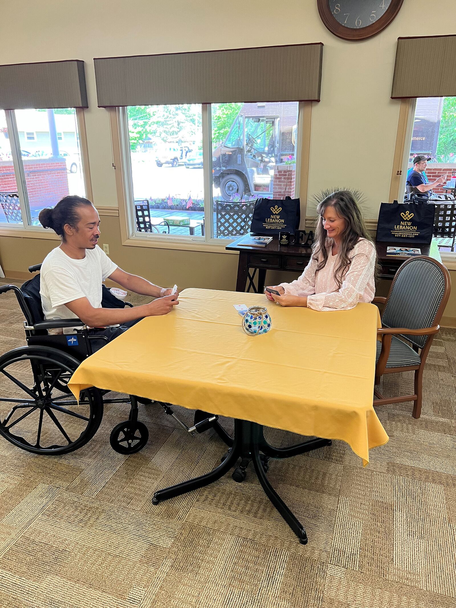 Danielle Feltner decided to build her career in the long-term care field after realizing how much she enjoyed caring for residents when she was a teenager working in a housekeeping role. She is shown with New Lebanon Rehabilitation & Health Care Center resident Daryl Montgomery (left) playing cards. CONTRIBUTED