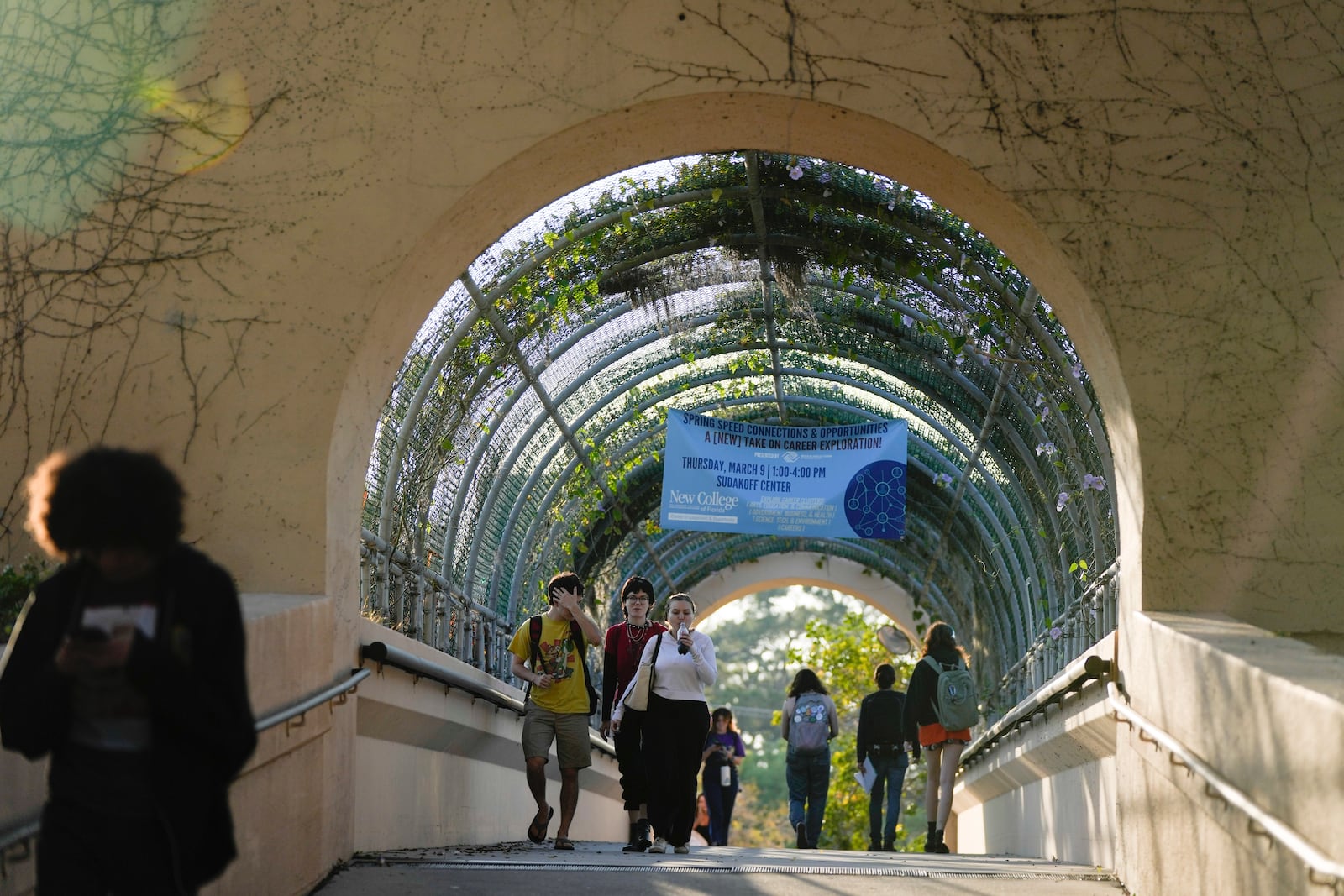 FILE - Students cross a bridge linking different sections of the campus, at New College of Florida, Feb. 28, 2023, in Sarasota, Fla. For years, students have come to this public liberal arts college on the western coast of Florida because they were self-described free thinkers. Now they find themselves caught in the crosshairs of America's culture war. (AP Photo/Rebecca Blackwell)