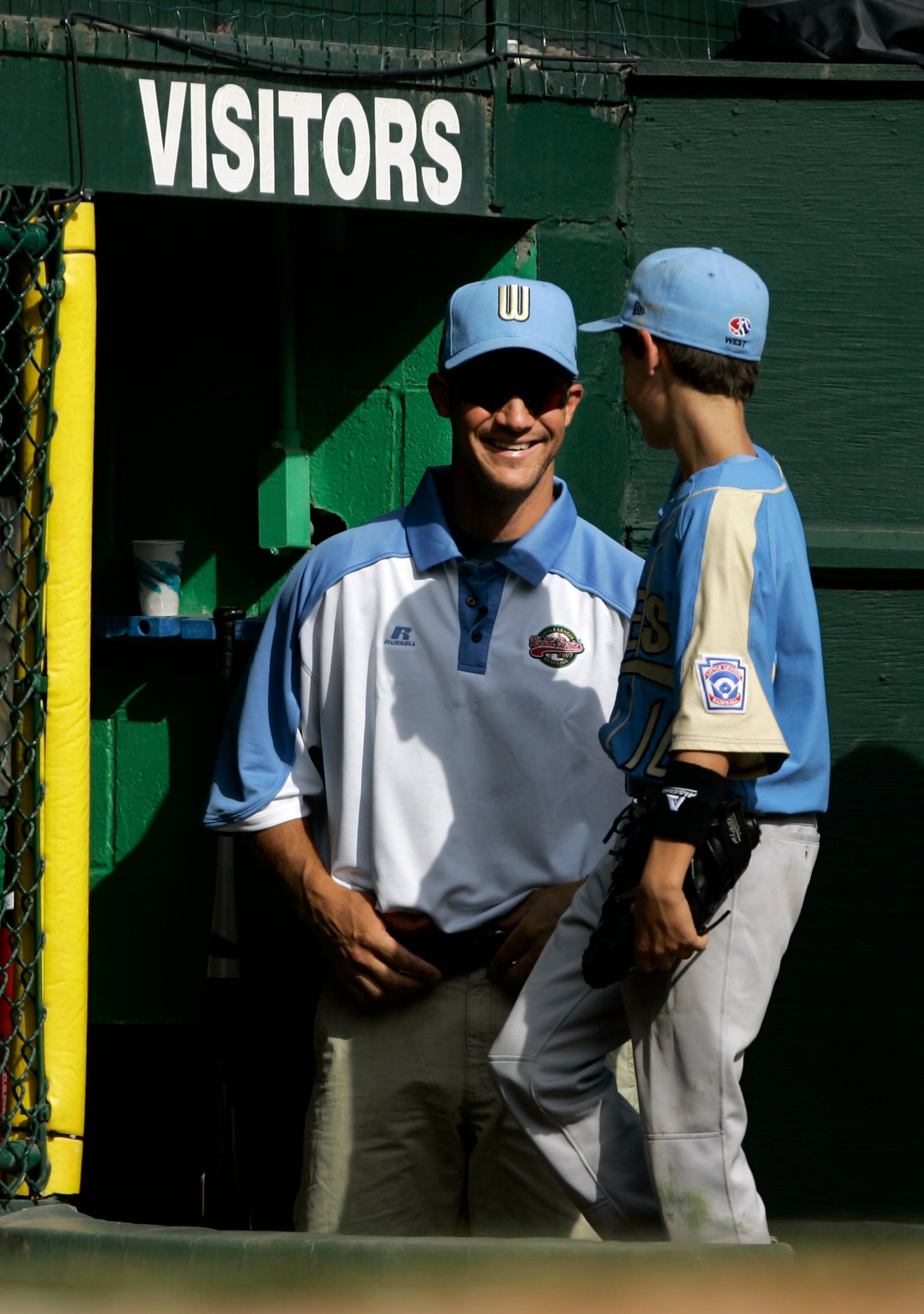 FILE - Chandler Ariz., coach Clay Bellinger, left, smiles at his son and Arizona player Cody Bellinger as they come into the dugout in the third inning against Salisbury, Md., during the 2007 Little League World Series pool play in South Williamsport, Pa., on Saturday, Aug. 18, 2007. (AP Photo/Carolyn Kaster, File)