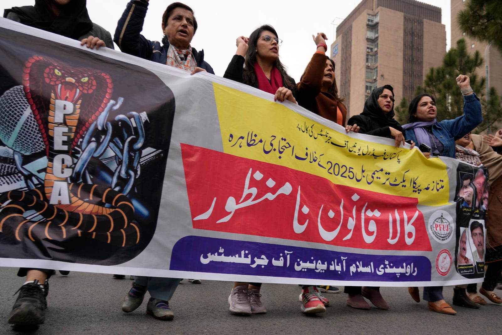 Journalists chant slogans during a protest rally in Islamabad, Pakistan, Tuesday, Jan. 28, 2025, to condemn a controversial 'Prevention of Electronic Crimes Act' bill passed by parliament that critics argue is designed to suppress freedom of speech. The banner reading as 'Reject Black Act'. (AP Photo/Anjum Naveed)