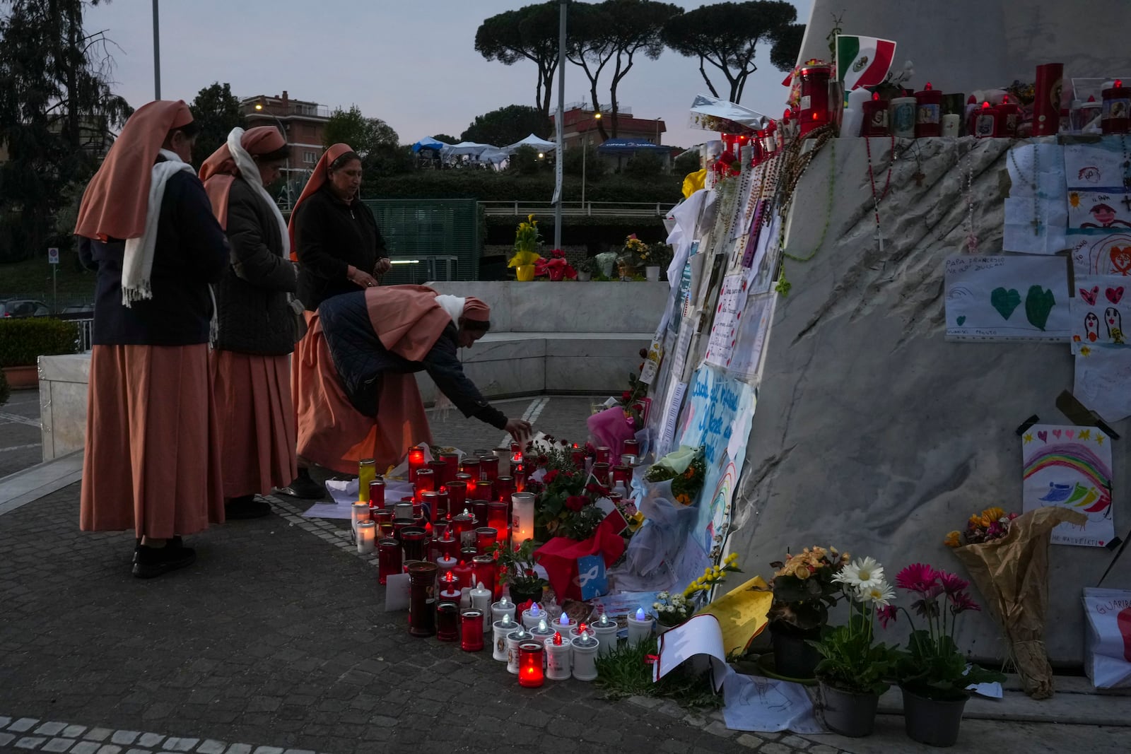 Nuns pray for Pope Francis in front of the Agostino Gemelli Polyclinic, in Rome, Saturday, March 8, 2025, where the Pontiff is hospitalized since Friday, Feb. 14. (AP Photo/Andrew Medichini)