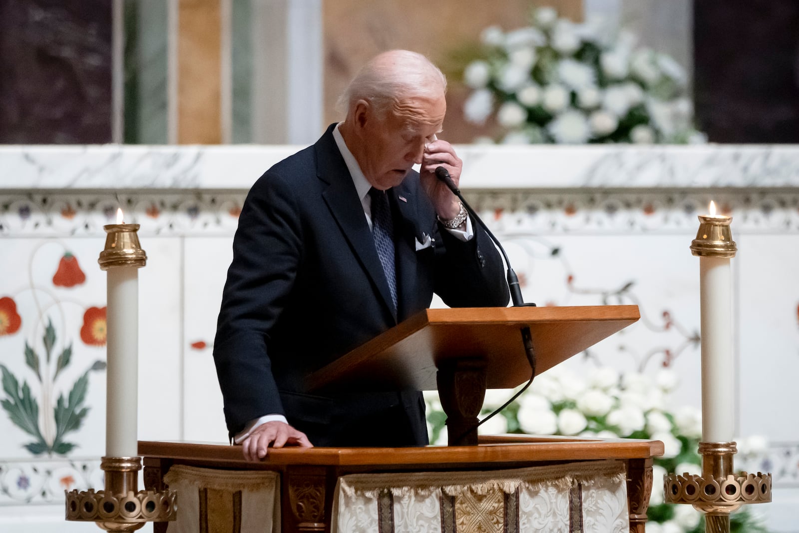 President Joe Biden dabs his eye with a tissue as he speaks at a memorial service for Ethel Kennedy, the wife of Sen. Robert F. Kennedy, who died Oct. 10, 2024 at age 96, at the Cathedral of St. Matthew the Apostle in Washington, Wednesday, Oct. 16, 2024. (AP Photo/Ben Curtis)