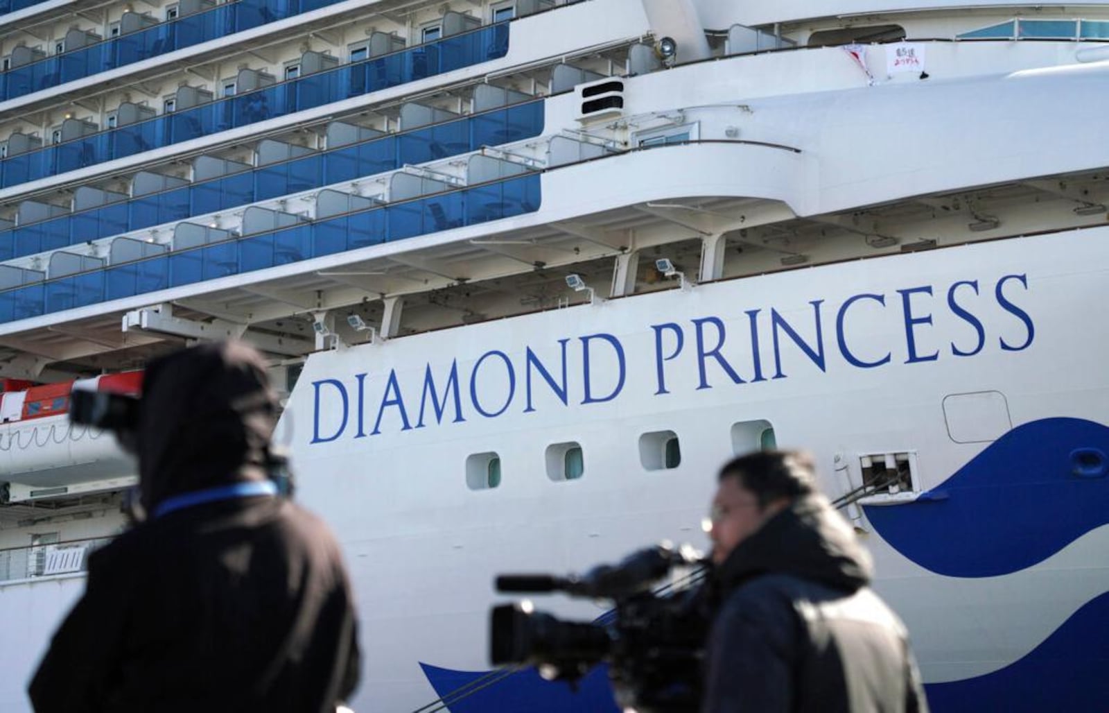 The quarantined cruise ship Diamond Princess is anchored in the Yokohama Port Sunday, Feb. 9, 2020. Japan on Saturday reported three more cases of the coronavirus aboard the Diamond Princess for a total of 64 . There are 3,700 passengers and crew on the Diamond Princess who must remain on board for 14 days. (AP Photo/Eugene Hoshiko)