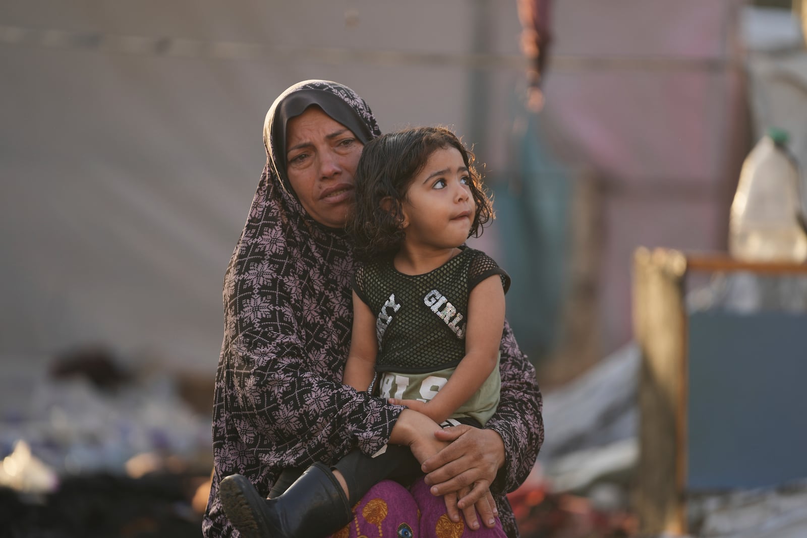 Palestinians look at the damage after an Israeli strike hit a tent area in the courtyard of Al Aqsa Martyrs hospital in Deir al Balah, Gaza Strip, Monday, Oct. 14, 2024. (AP Photo/Abdel Kareem Hana)