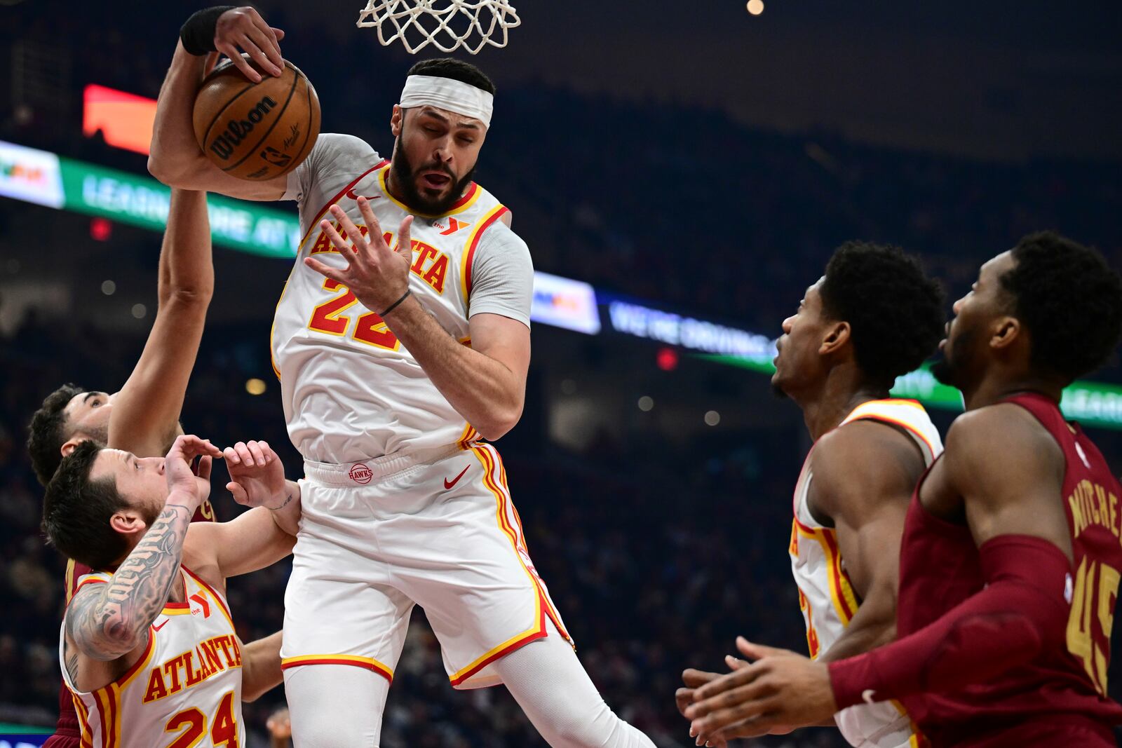 Atlanta Hawks forward Larry Nance Jr., top, rebounds in the first half of an NBA basketball game against the Cleveland Cavaliers, Thursday, Jan. 30, 2025, in Cleveland. (AP Photo/David Dermer)