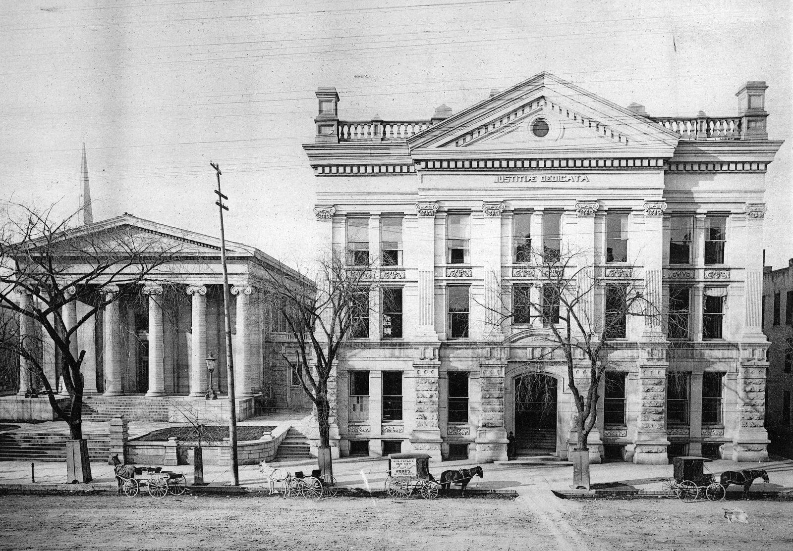 Two court houses, standing side by side, encompassed a block of downtown Dayton for many years. The Old Court House (left) was competed in 1850 and a new larger court house (right) opened in 1884.  DAYTON METRO LIBRARY