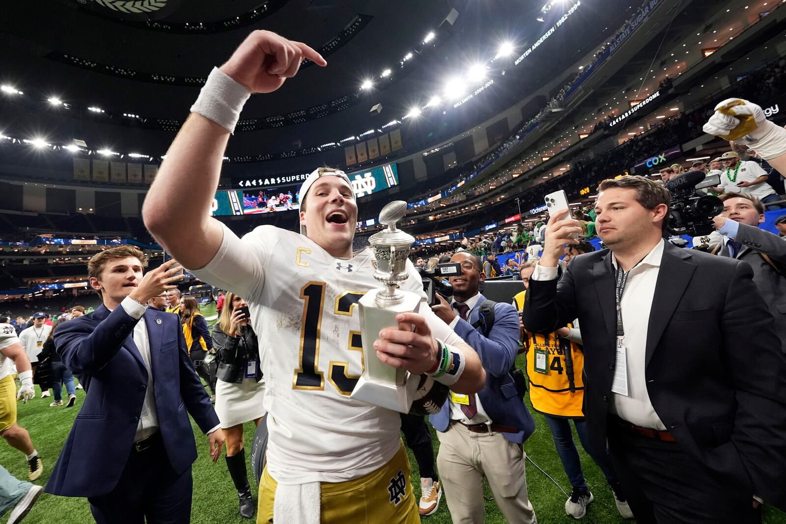 FILE- Notre Dame quarterback Riley Leonard (13) celebrates after a quarterfinal game against Georgia in the College Football Playoff, Thursday, Jan. 2, 2025, in New Orleans. (AP Photo/Gerald Herbert, File)