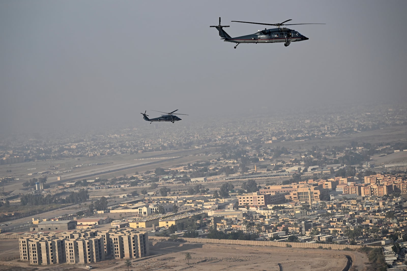 US State Department Sikorsky HH-60L Black Hawk helicopters escort Secretary of State Antony Blinken as they fly over Baghdad towards the US embassy headquarters on Friday, Dec. 13, 2024. (Andrew Caballero-Reynolds/Pool Photo via AP)