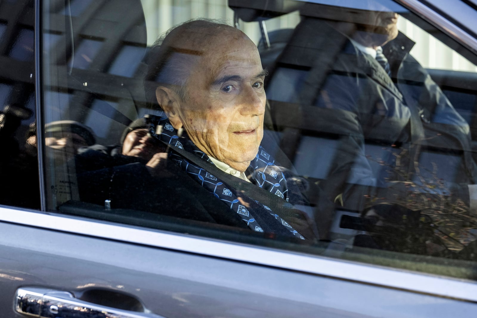 Ex-FIFA president Sepp Blatter, center, arrives in front of the special appeals court in Muttenz, Switzerland, for his retrial on fraud, forgery and misappropriation charges Monday, March 3, 2025. (Urs Flueeler/Keystone via AP)10