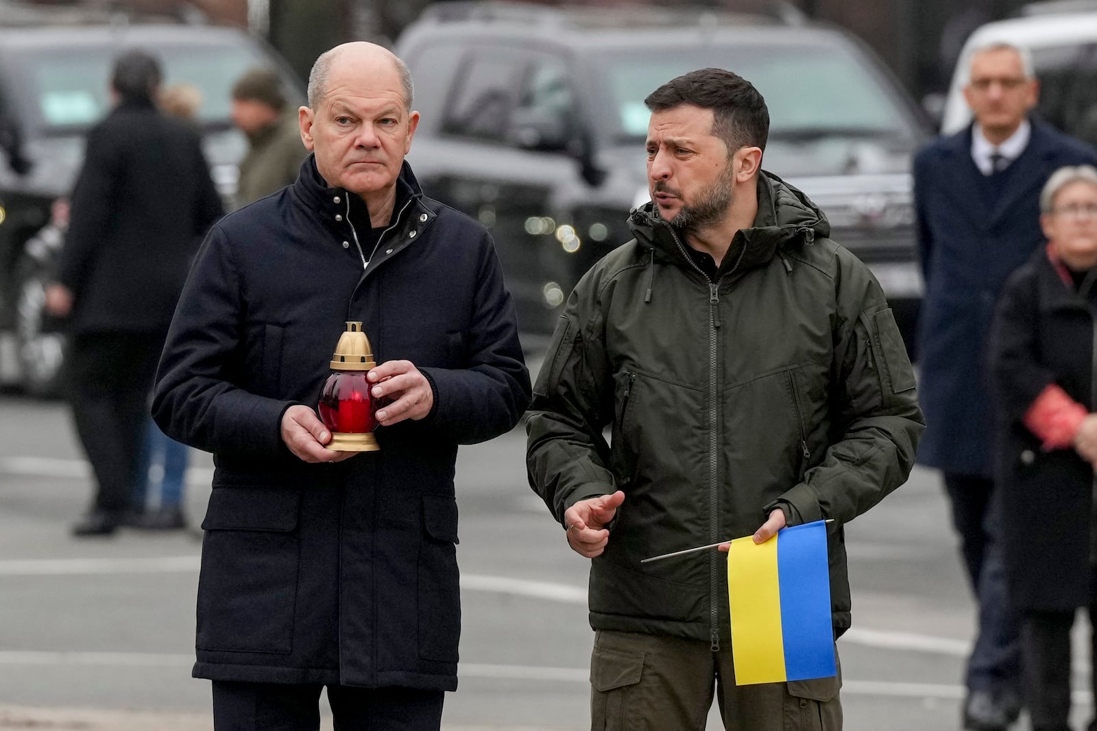 Ukraine's President Volodymyr Zelenskyy, right, and German Chancellor Olaf Scholz attend a ceremony of honoring fallen soldiers near the People's Memorial of National Memory in Kyiv, Ukraine, Monday, Dec.2, 2024. (AP Photo/Evgeniy Maloletka)