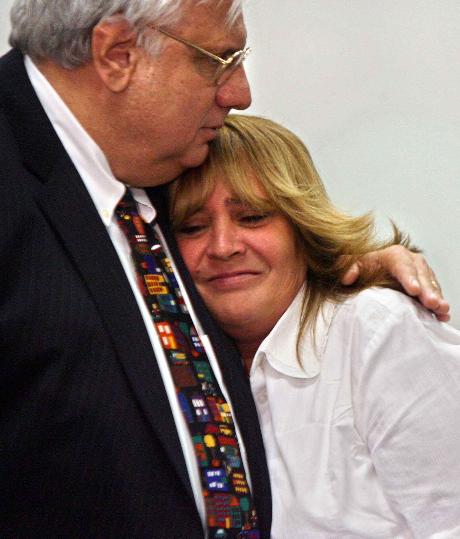 Mike Fox, executive director of the Butler County Children Services Board, hugs Sherri Jackson after a press conference held in her support Tuesday at Butler County Children Services in Hamilton. Staff photo by Nick Daggy