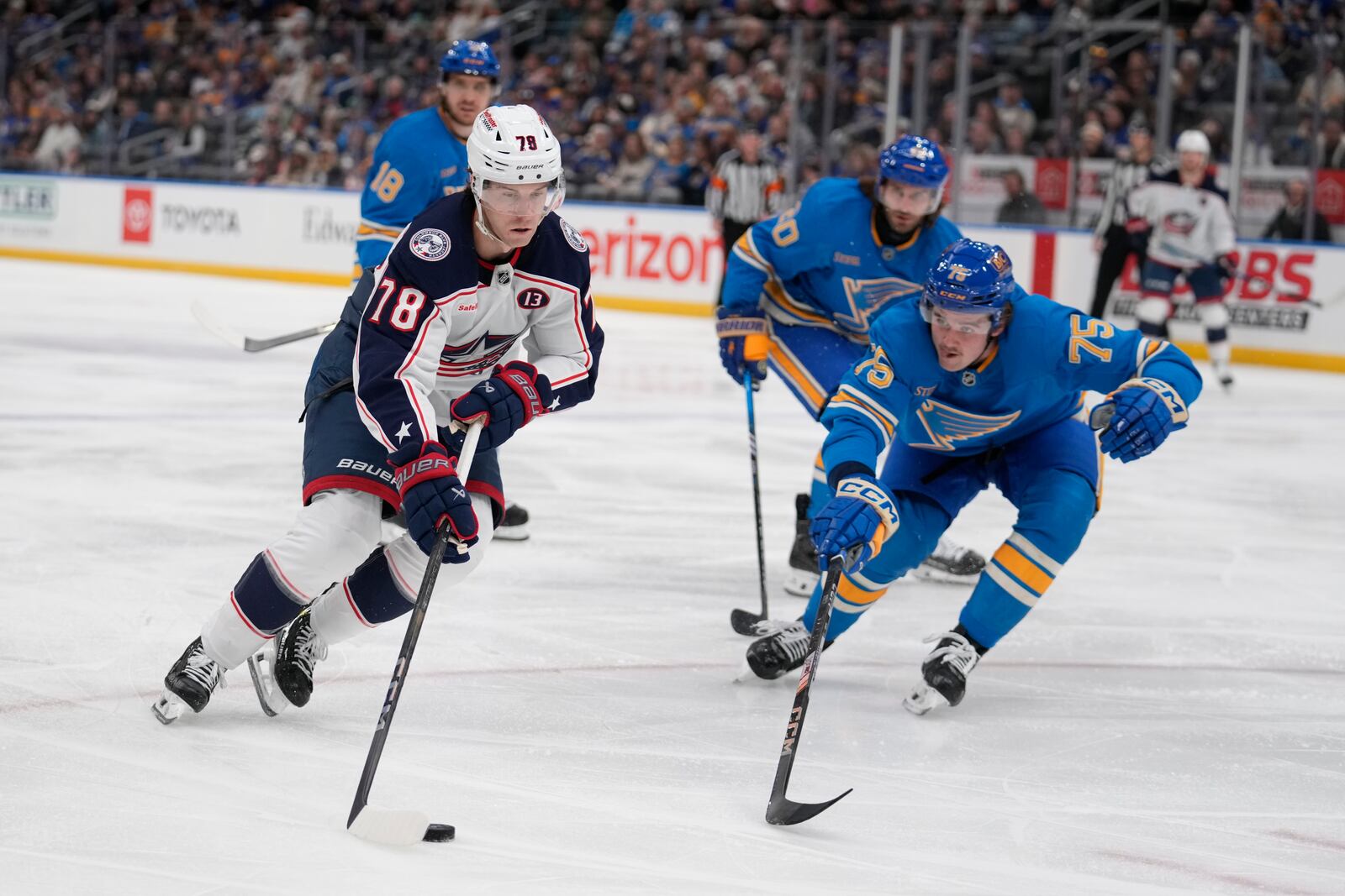 Columbus Blue Jackets' Damon Severson (78) handles the puck as St. Louis Blues' Tyler Tucker (75) defends during the third period of an NHL hockey game Saturday, Jan. 11, 2025, in St. Louis. (AP Photo/Jeff Roberson)