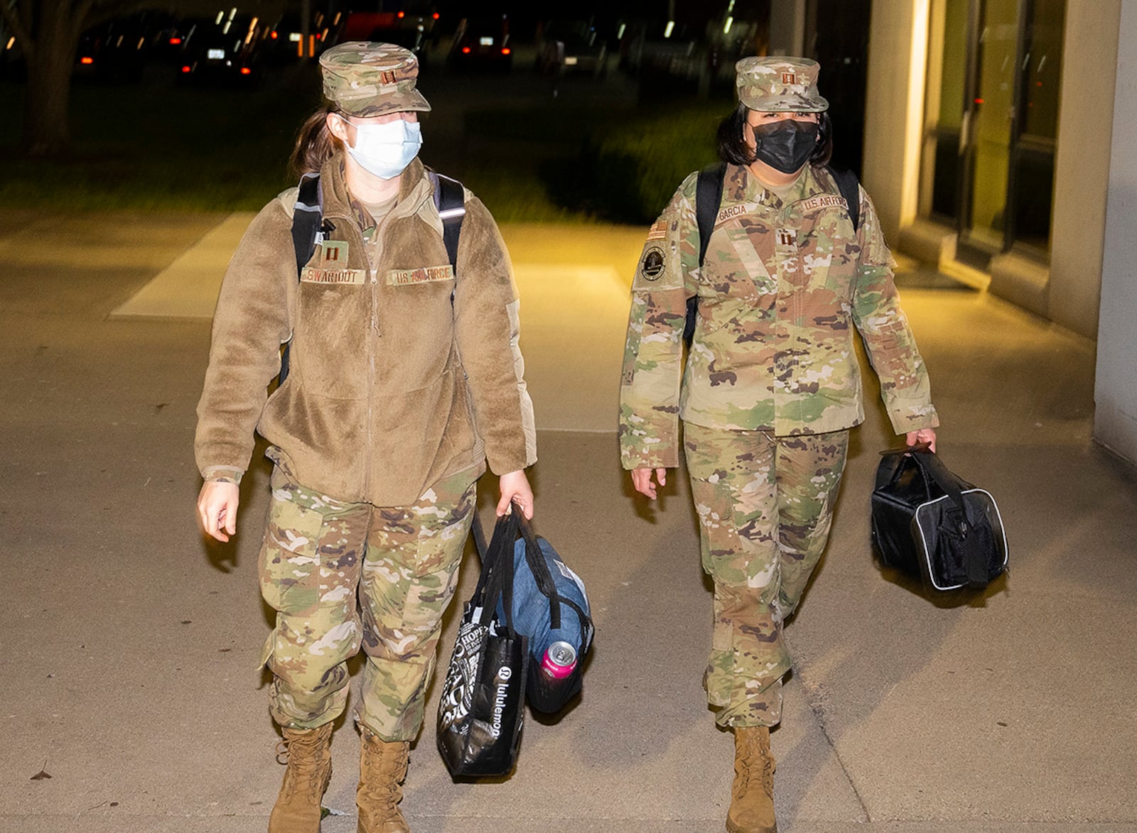 Capts. Breanna Swartout (left) and Dahlia Garcia arrive at Wright-Patterson Medical Center at 5:50 p.m. Dec. 15 to start their shift in the Labor and Delivery Ward. The 12-hour shift takes them through the night and flips days to nighttime. U.S. AIR FORCE PHOTO/R.J. ORIEZ