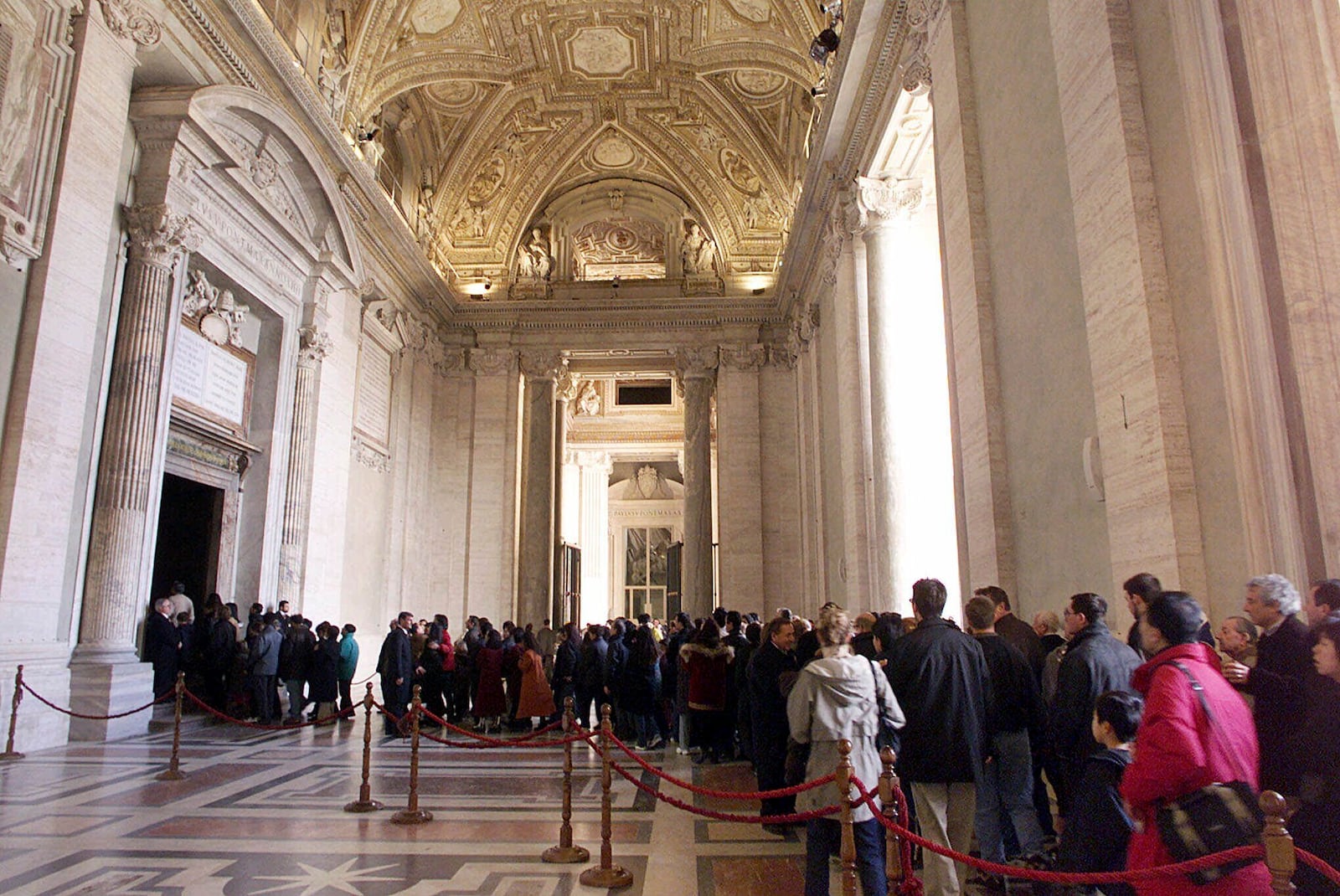 FILE - Pilgrims line to walk through St. Peter's Basilica's Holy Door at the Vatican, Tuesday, December 28, 1999. (AP Photo/Massimo Sambucetti, File)