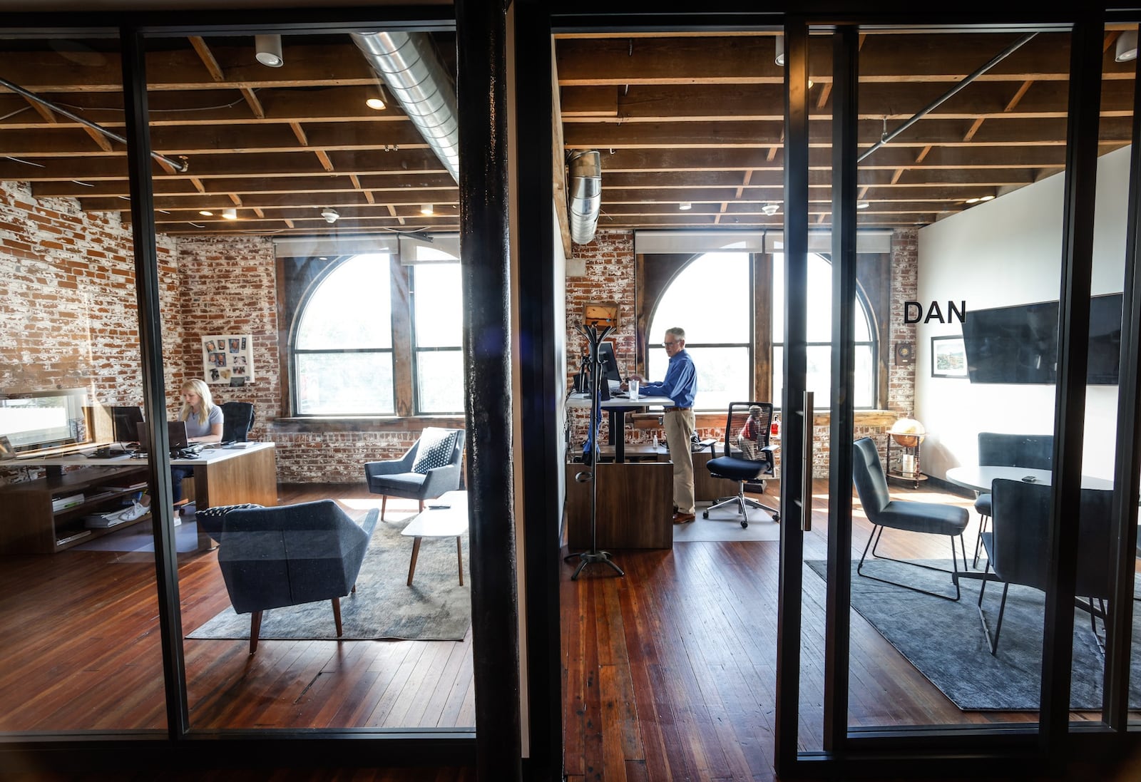 Carly Cox, left and Dan Marion of JJR Solutions work in their offices in the Avant Garde Building on East Third Street in Dayton. JIM NOELKER/STAFF