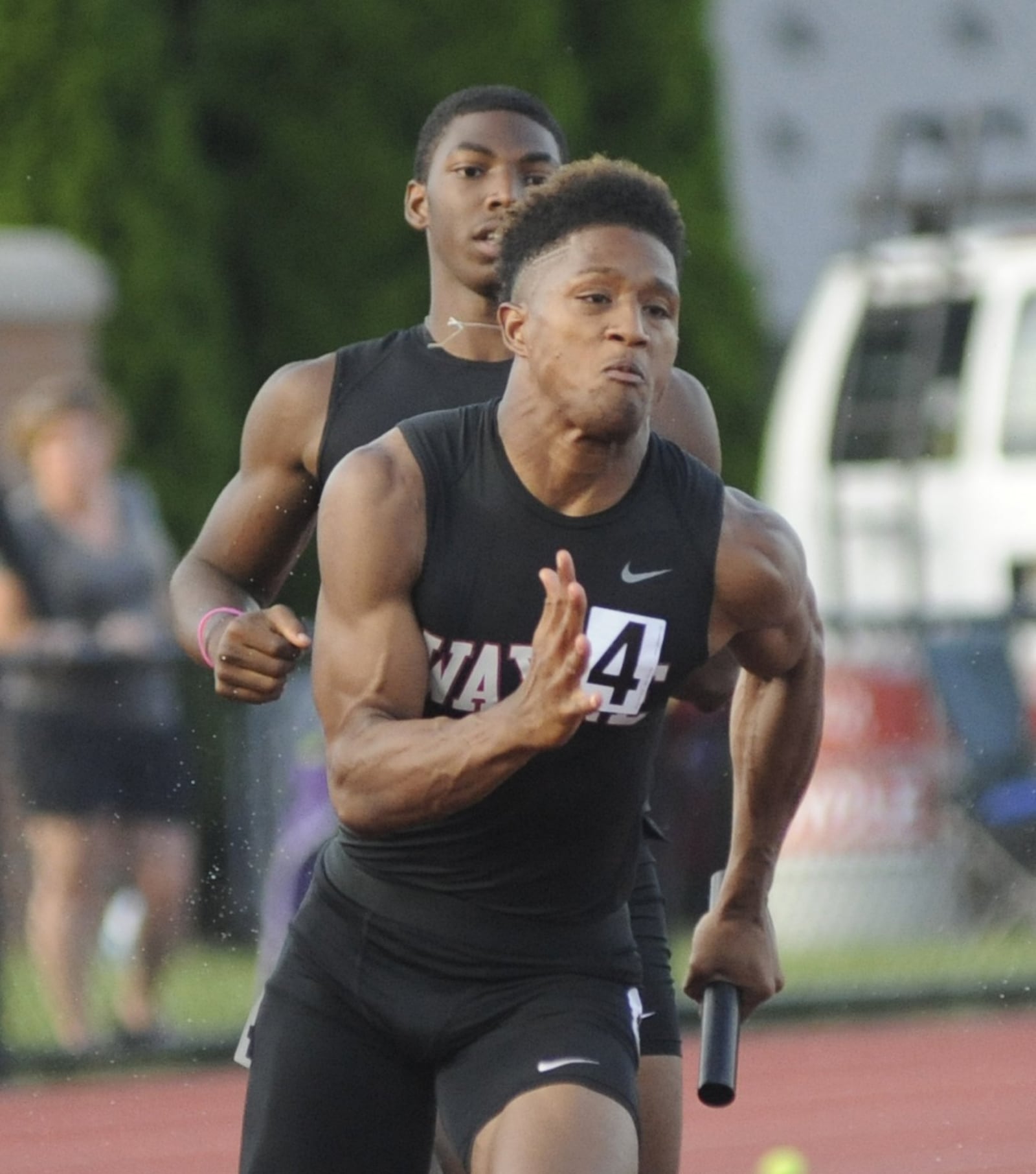 Wayne junior sprinter Zarik Brown (front) injured himself after getting a baton handoff from teammate Justin Harris during the D-I state track and field meet in Columbus on Friday, June 1, 2018. MARC PENDLETON / STAFF